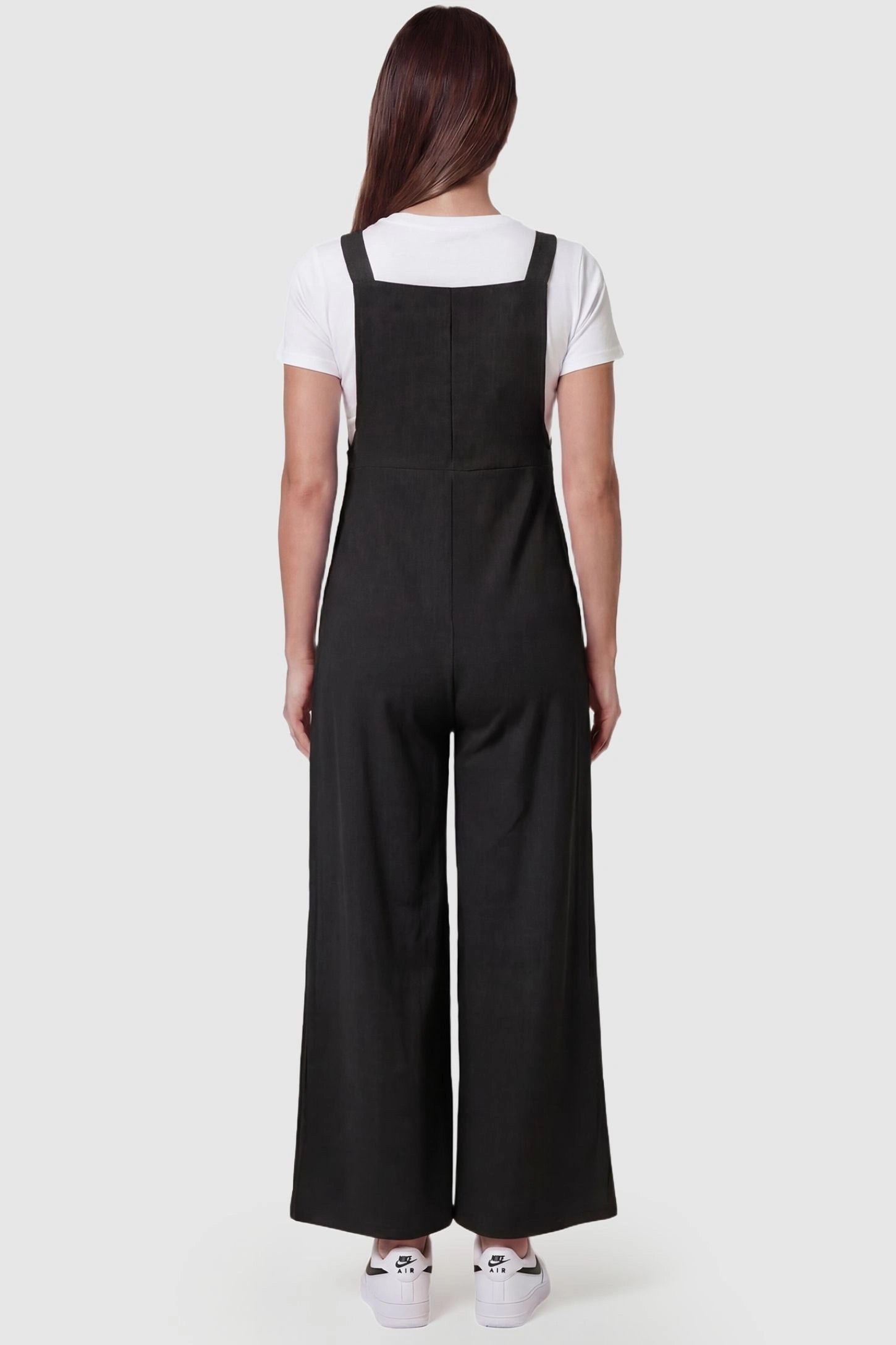 Full-Length Pocketed Maternity Jumpsuit Full-Length Pocketed Maternity Jumpsuit in Black featuring relaxed fit on a pregnant model, back view.