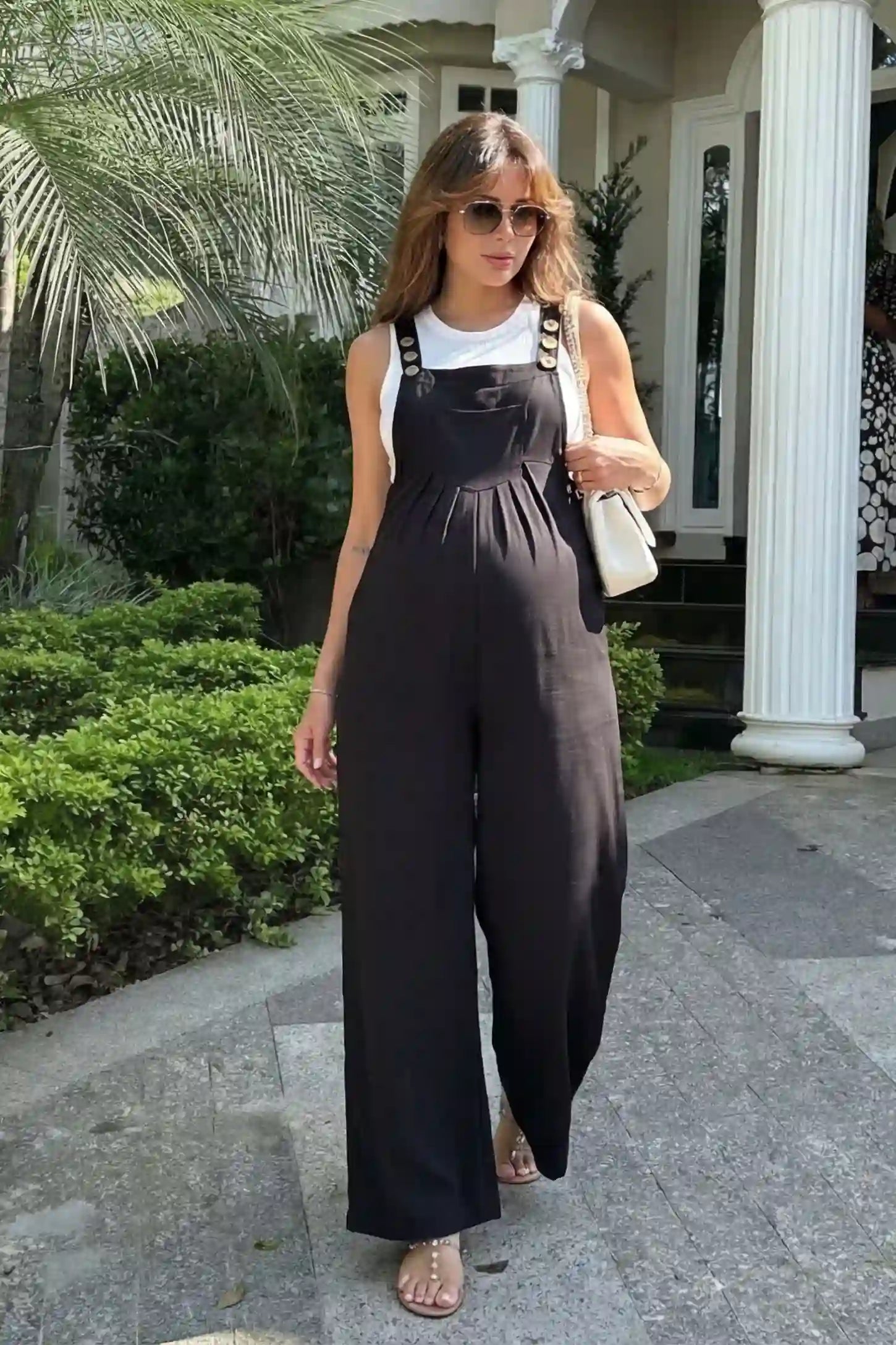 Full-Length Pocketed Maternity Jumpsuit Full-Length Pocketed Maternity Jumpsuit in Black featuring adjustable straps and a relaxed fit on a pregnant model, front view.