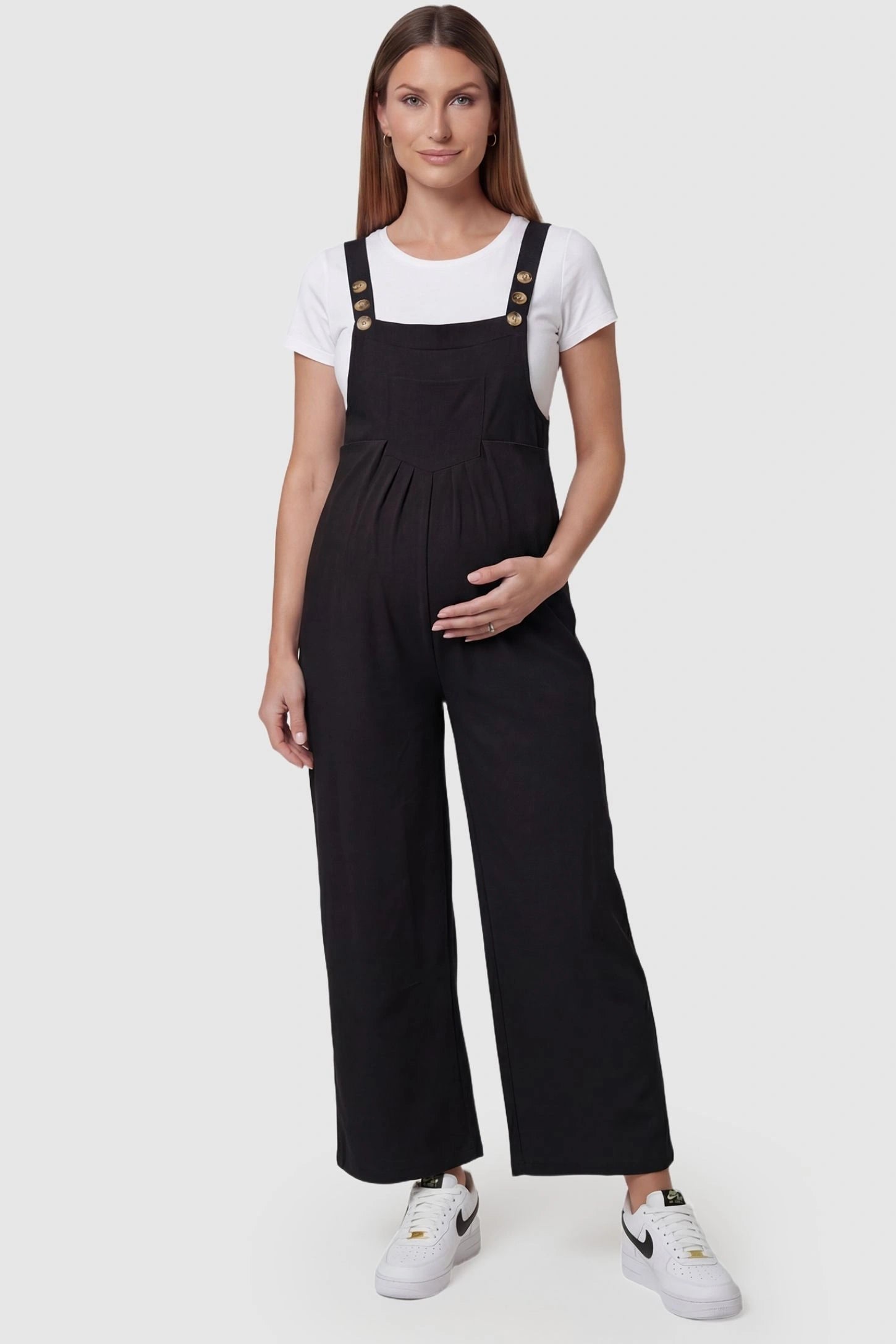 Full-Length Pocketed Maternity Jumpsuit Full-Length Pocketed Maternity Jumpsuit in Black featuring adjustable straps and a relaxed fit on a pregnant model, front view.