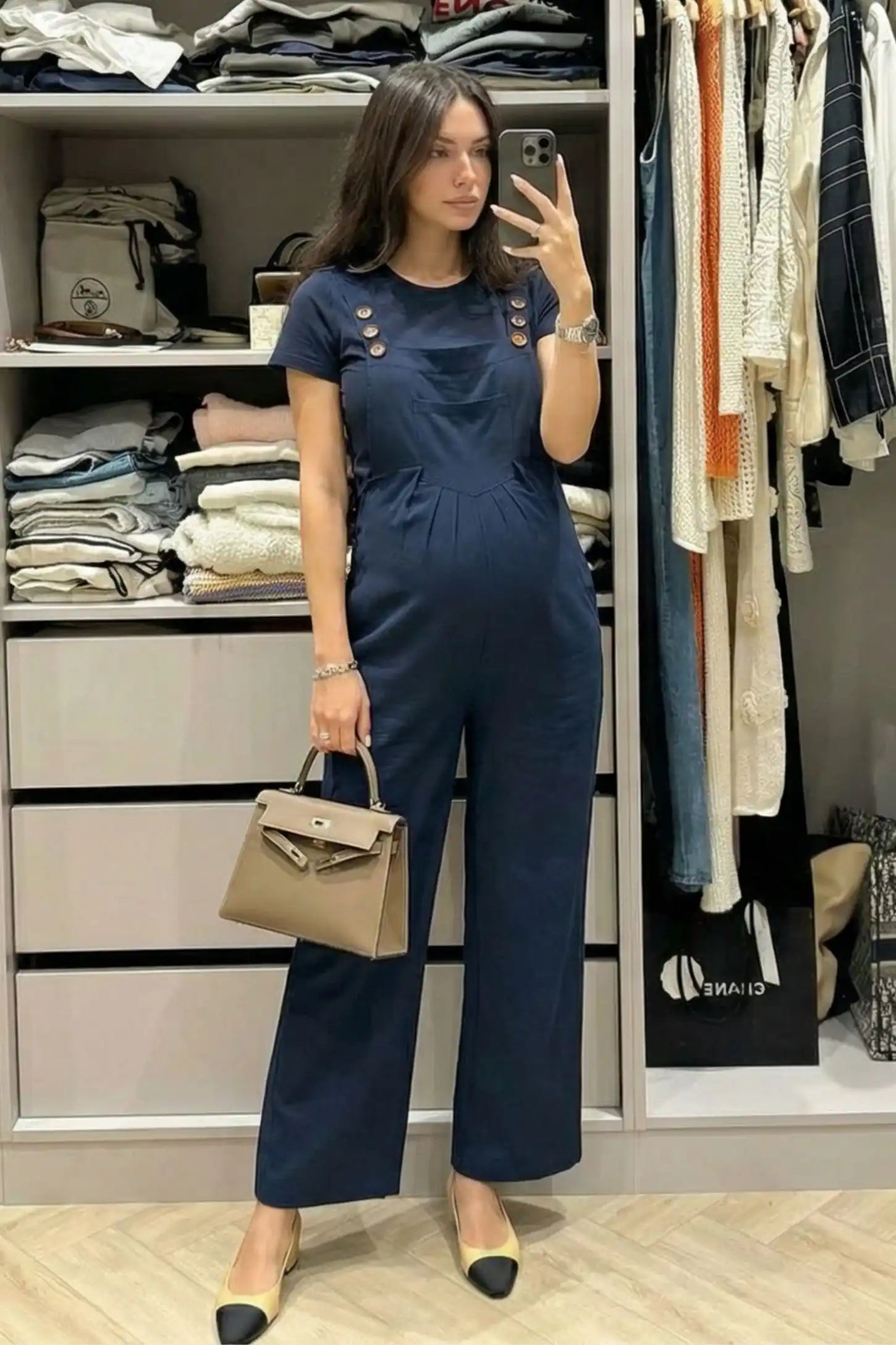 Full-Length Pocketed Maternity Jumpsuit Full-Length Pocketed Maternity Jumpsuit in Dark Blue featuring adjustable straps and a relaxed fit on a pregnant model, front view.