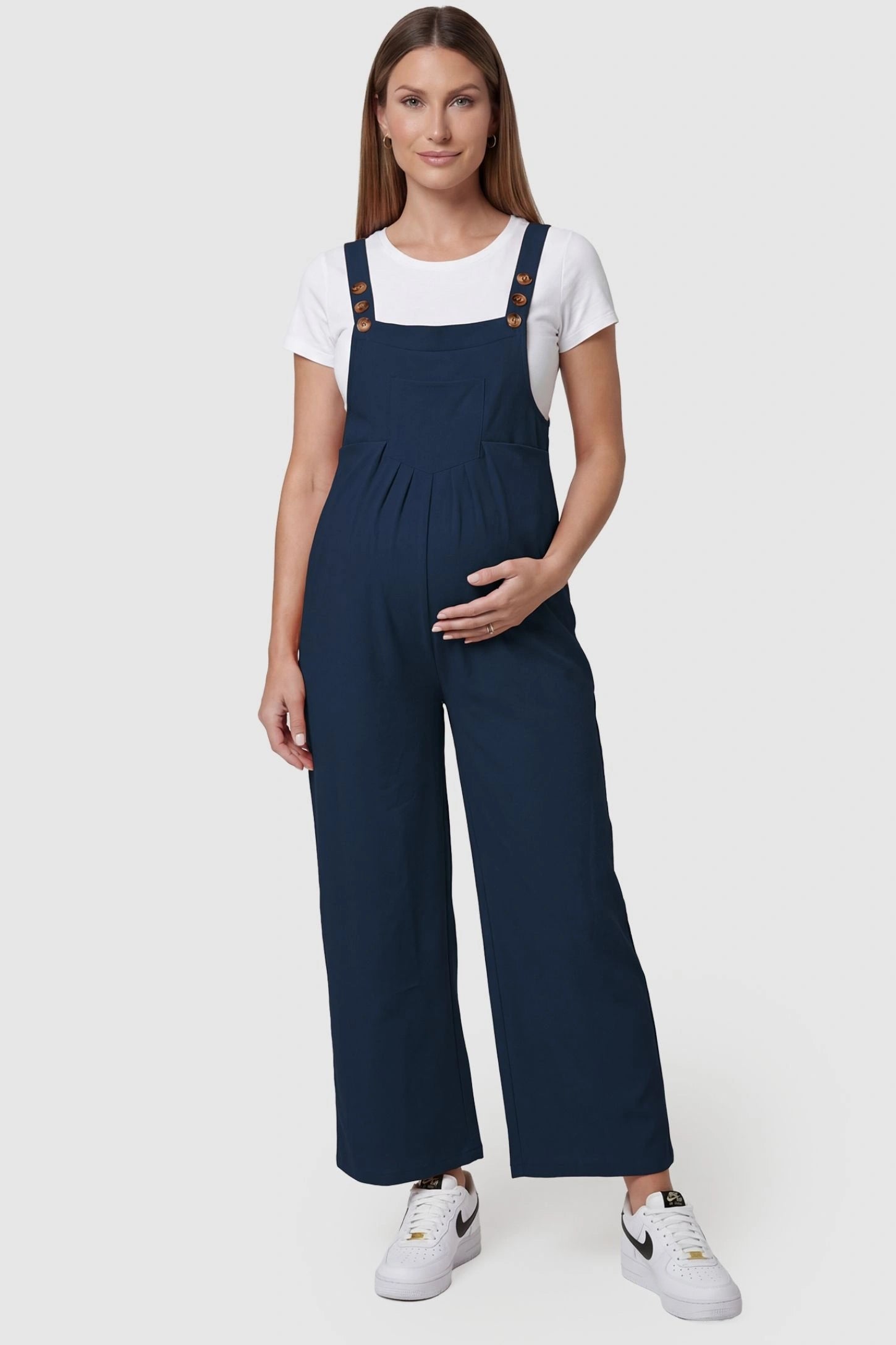 Full-Length Pocketed Maternity Jumpsuit Full-Length Pocketed Maternity Jumpsuit in Dark Blue featuring adjustable straps and a relaxed fit on a pregnant model, front view.