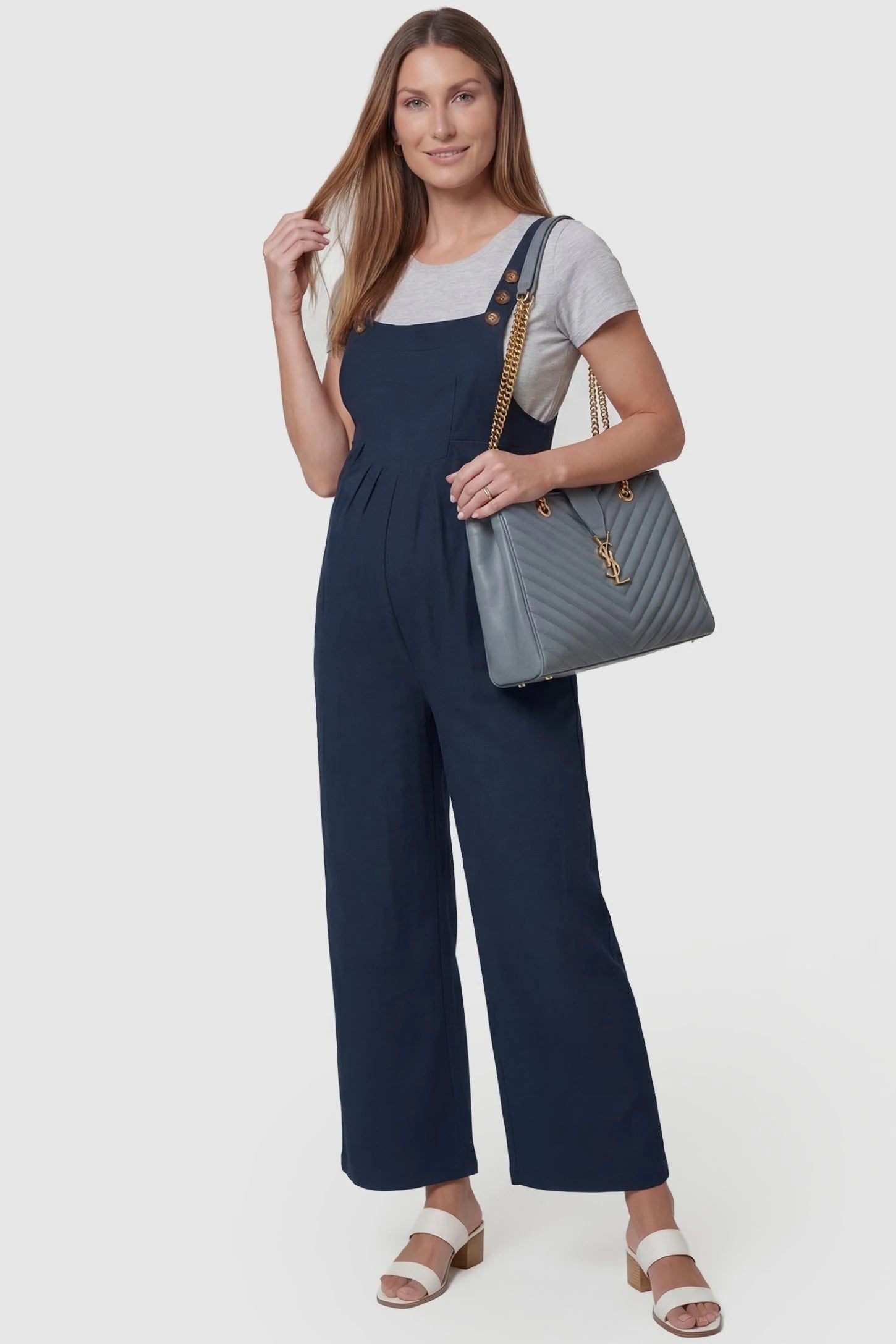 Full-Length Pocketed Maternity Jumpsuit Full-Length Pocketed Maternity Jumpsuit in Dark Blue featuring adjustable straps and a relaxed fit on a pregnant model, front view.