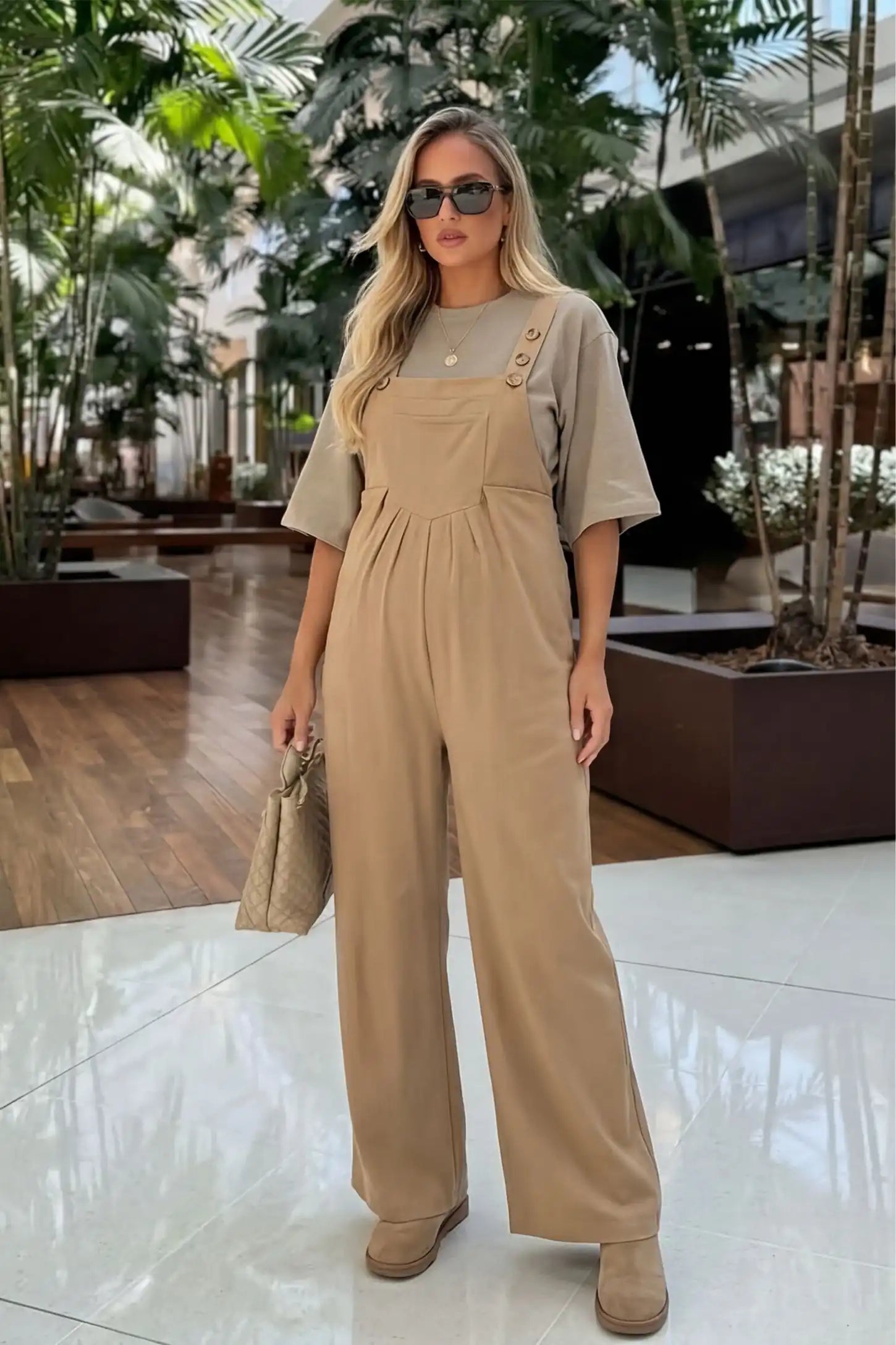 Full-Length Pocketed Maternity Jumpsuit Full-Length Pocketed Maternity Jumpsuit in Khaki featuring adjustable straps and a relaxed fit on a pregnant model, front view.