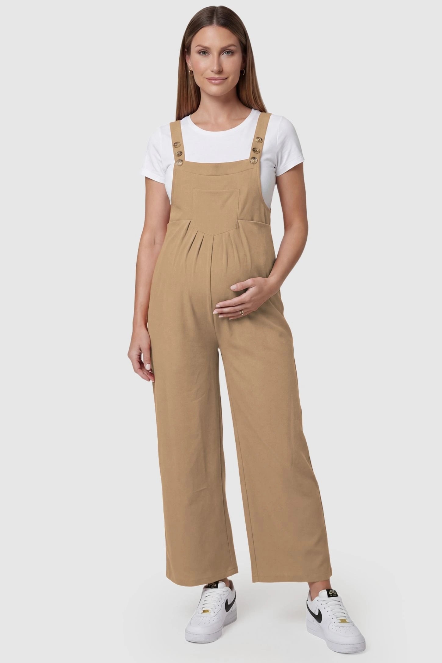 Full-Length Pocketed Maternity Jumpsuit Full-Length Pocketed Maternity Jumpsuit in Khaki featuring adjustable straps and a relaxed fit on a pregnant model, front view.