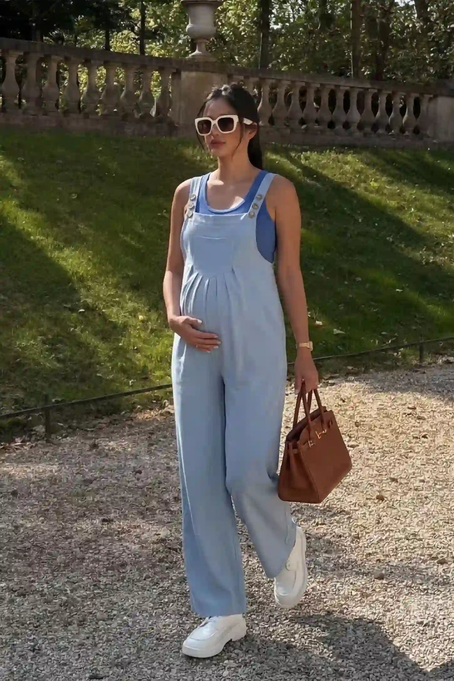 Full-Length Pocketed Maternity Jumpsuit Full-Length Pocketed Maternity Jumpsuit in Light Blue featuring adjustable straps and a relaxed fit on a pregnant model, side view.