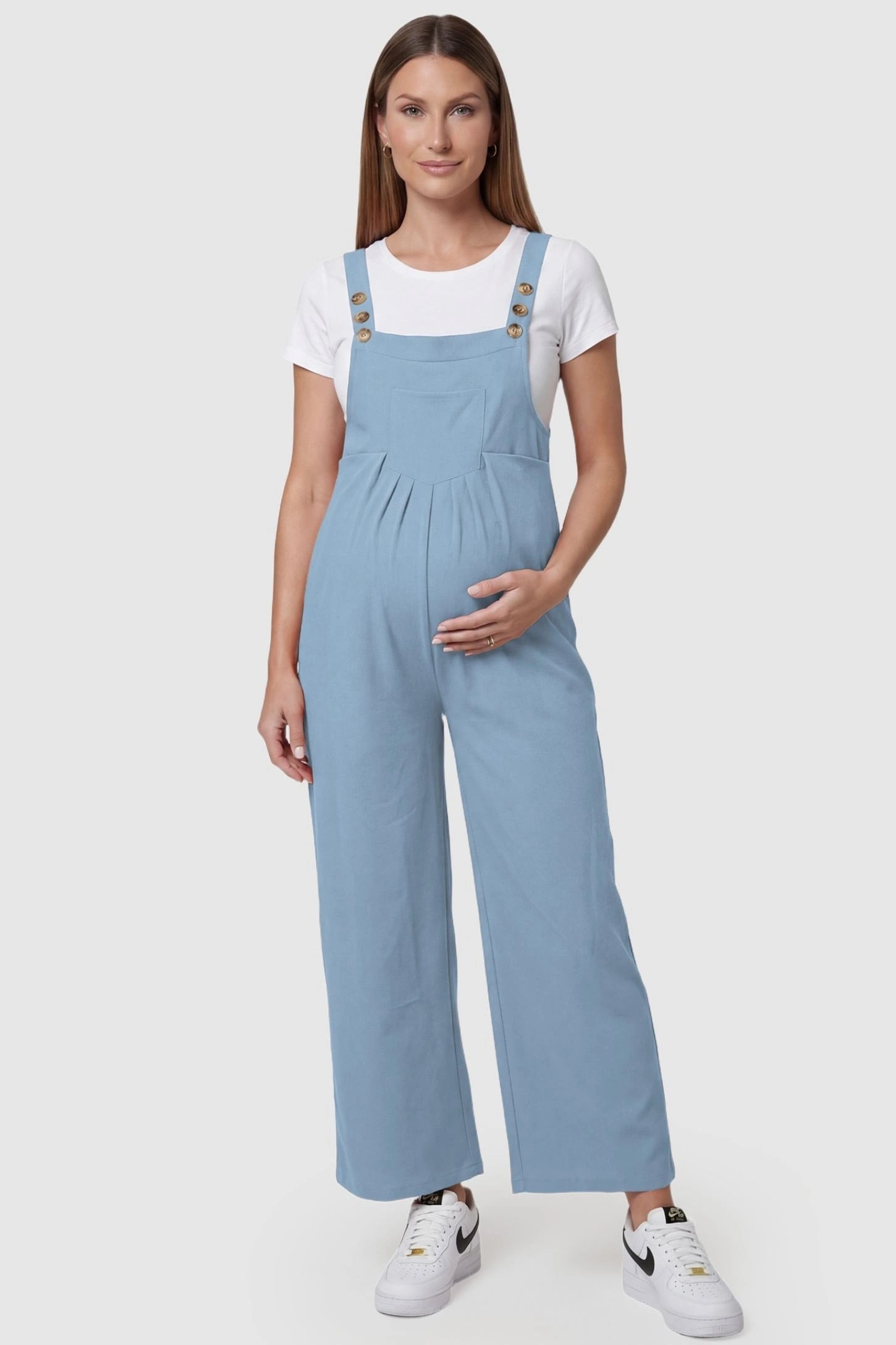 Full-Length Pocketed Maternity Jumpsuit Full-Length Pocketed Maternity Jumpsuit in Light Blue featuring adjustable straps and a relaxed fit on a pregnant model, front view.