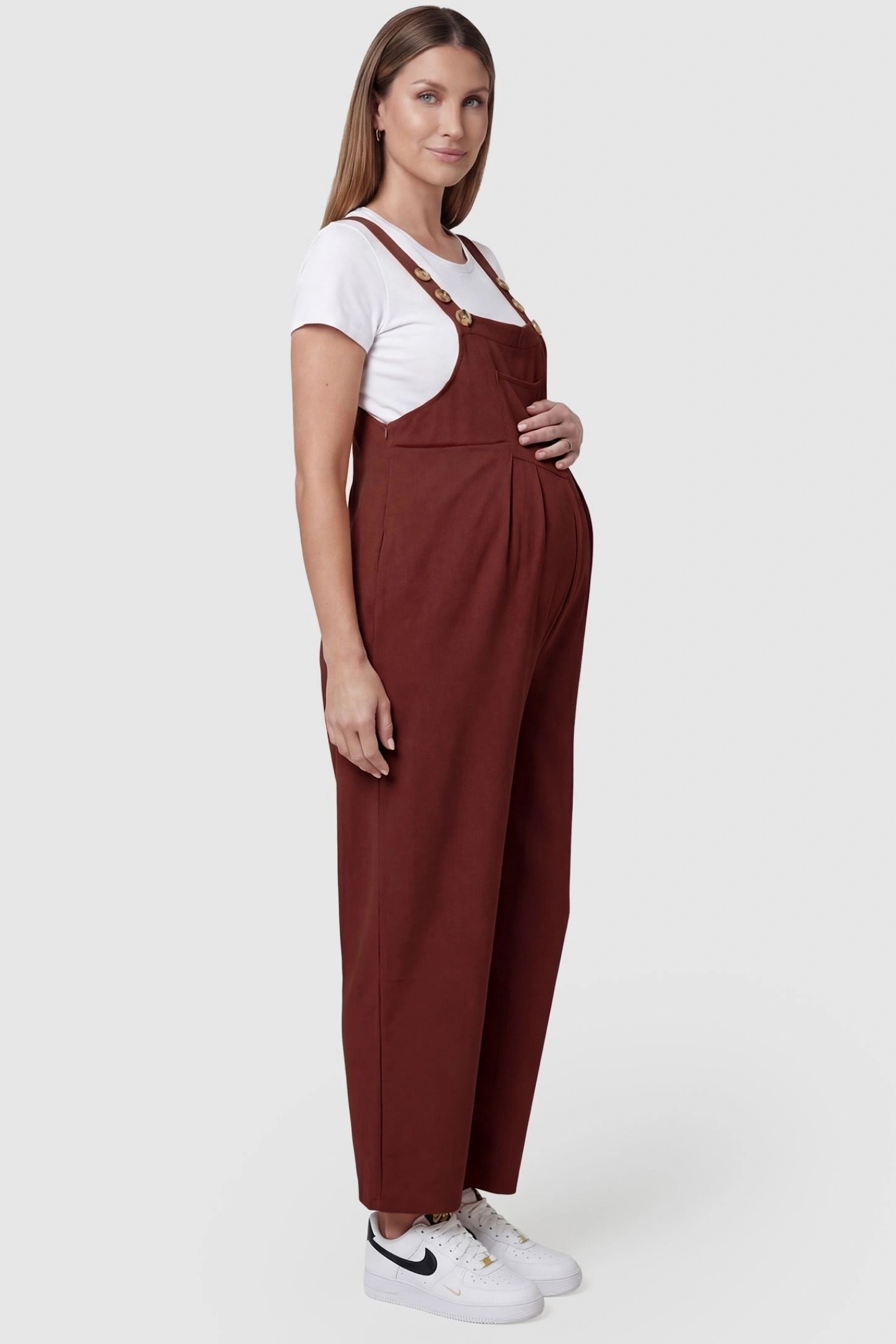 Full-Length Pocketed Maternity Jumpsuit Full-Length Pocketed Maternity Jumpsuit in Orange Red featuring adjustable straps and a relaxed fit on a pregnant model, side view.