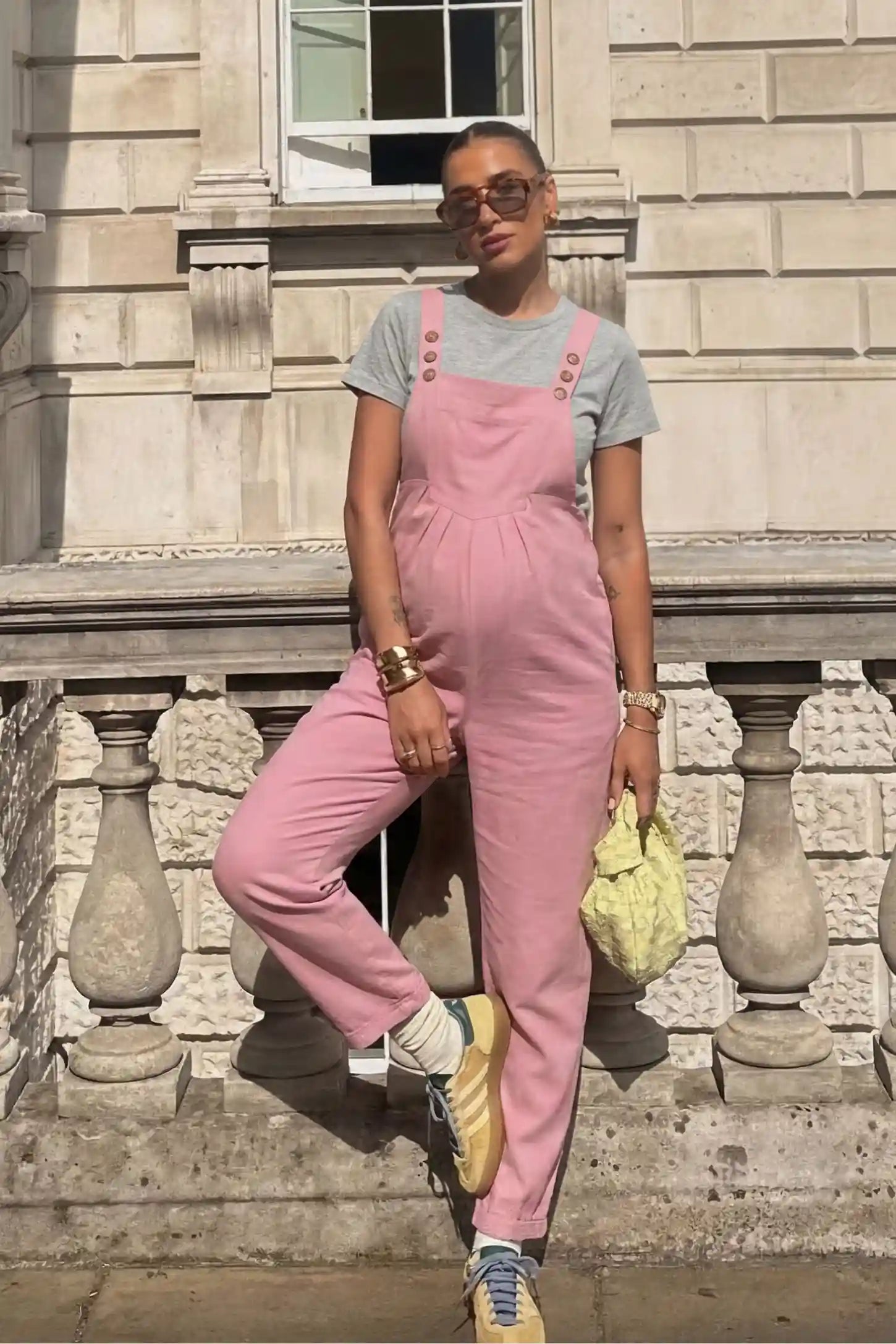 Full-Length Pocketed Maternity Jumpsuit Full-Length Pocketed Maternity Jumpsuit in Pink featuring adjustable straps and a relaxed fit on a pregnant model, front view.
