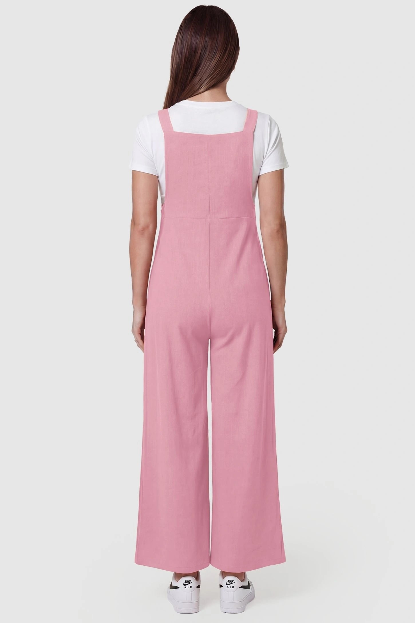 Full-Length Pocketed Maternity Jumpsuit Full-Length Pocketed Maternity Jumpsuit in Pink featuring relaxed fit on a pregnant model, back view.