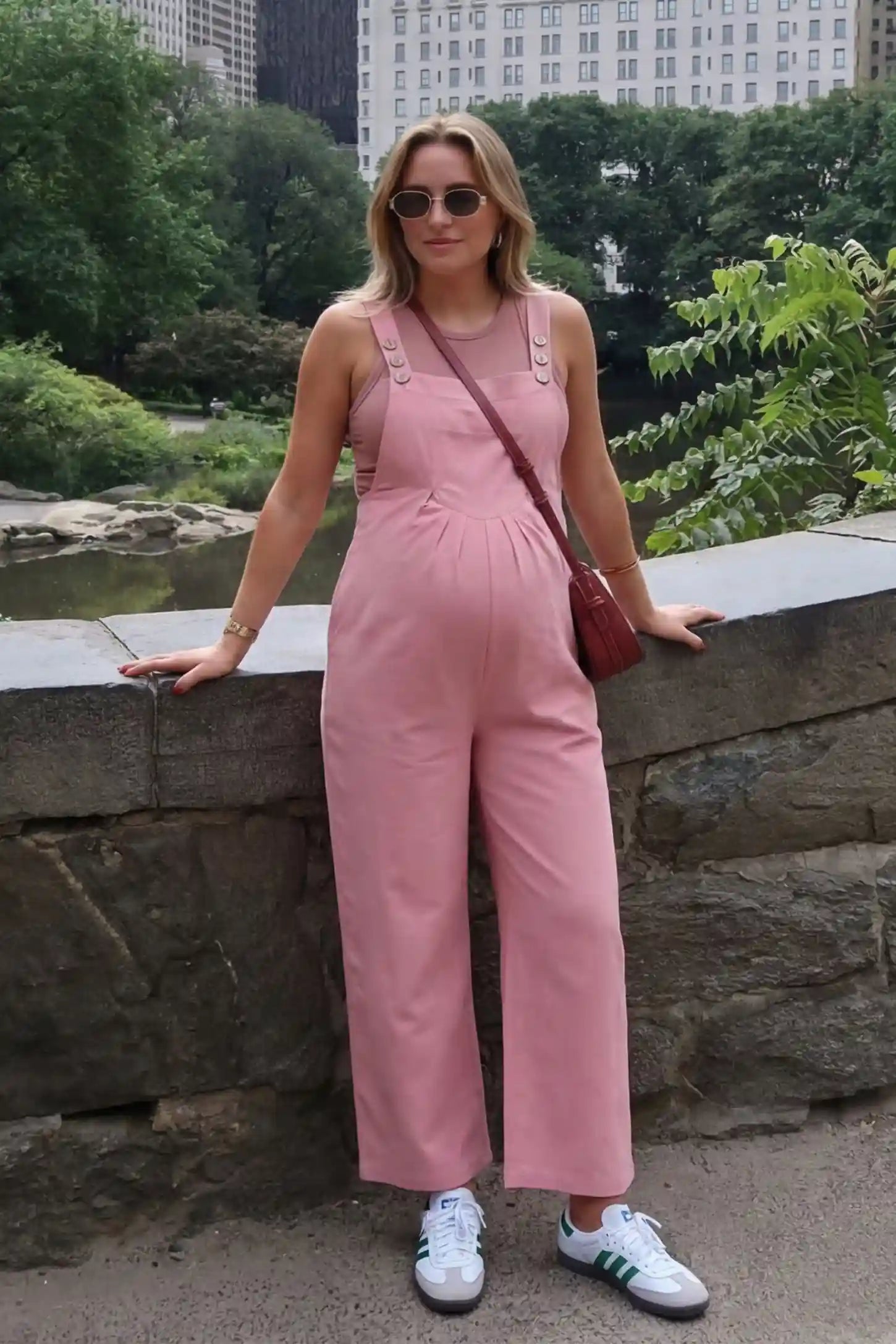 Full-Length Pocketed Maternity Jumpsuit Full-Length Pocketed Maternity Jumpsuit in Pink featuring adjustable straps and a relaxed fit on a pregnant model, front view.