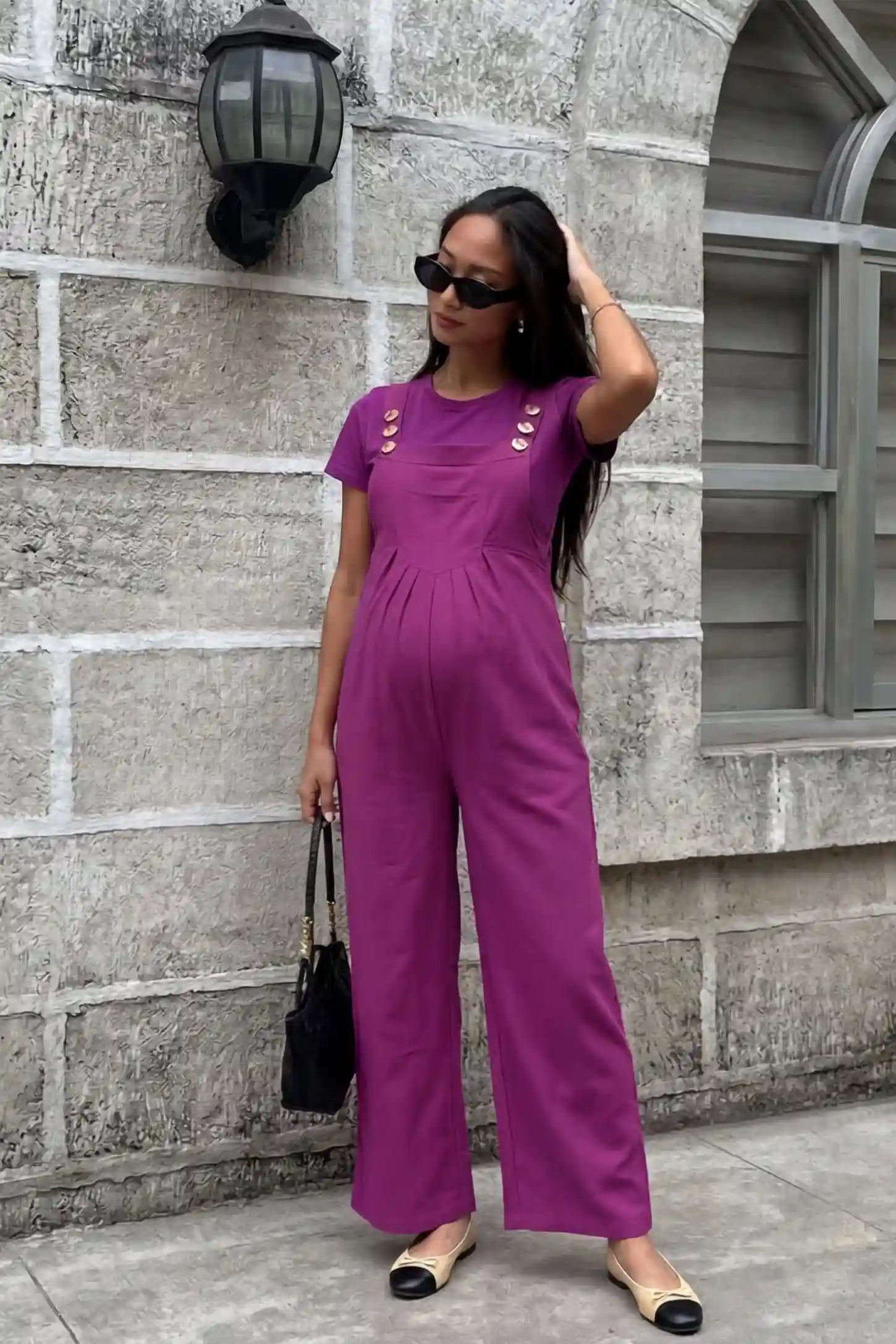 Full-Length Pocketed Maternity Jumpsuit Full-Length Pocketed Maternity Jumpsuit in Wine Red featuring adjustable straps and a relaxed fit on a pregnant model, front view.