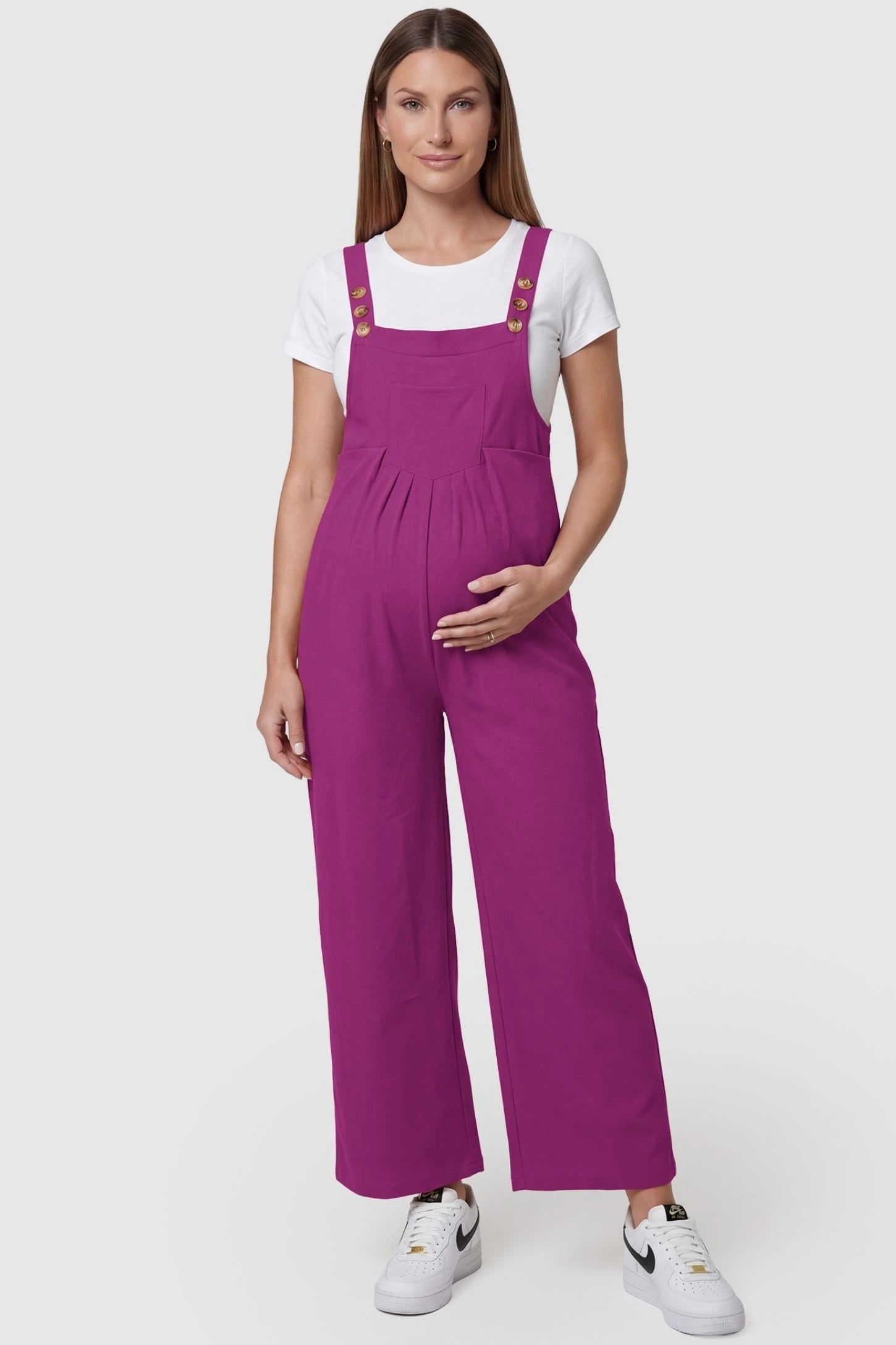Full-Length Pocketed Maternity Jumpsuit Full-Length Pocketed Maternity Jumpsuit in Wine Red featuring adjustable straps and a relaxed fit on a pregnant model, front view.