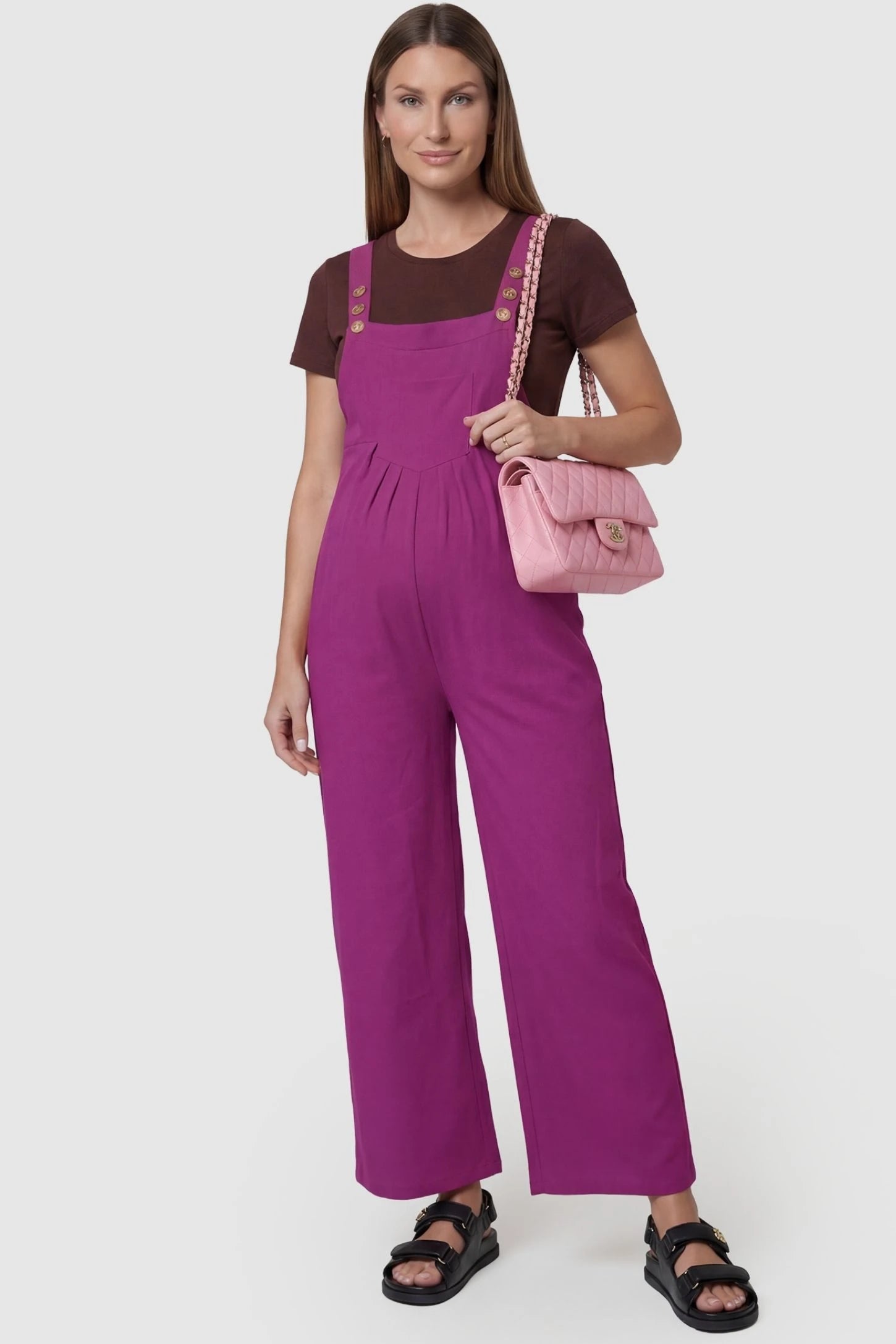 Full-Length Pocketed Maternity Jumpsuit Full-Length Pocketed Maternity Jumpsuit in Wine Red featuring adjustable straps and a relaxed fit on a pregnant model, front view.