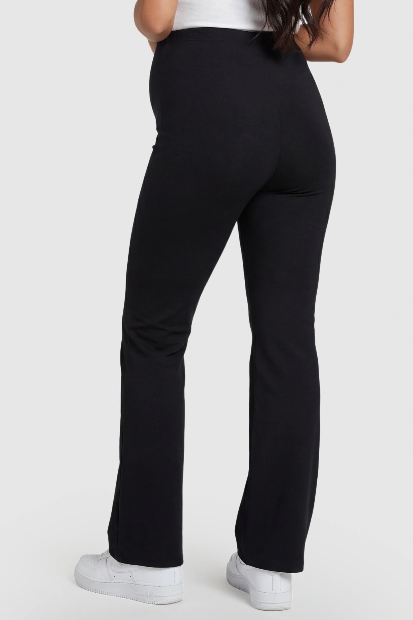 Buttery Soft High Waisted Flare Leg Maternity Pants Buttery Soft High Waisted Flare Leg Maternity Pants in black featuring a butt-lifting sculpting seam on a pregnant model, back view.