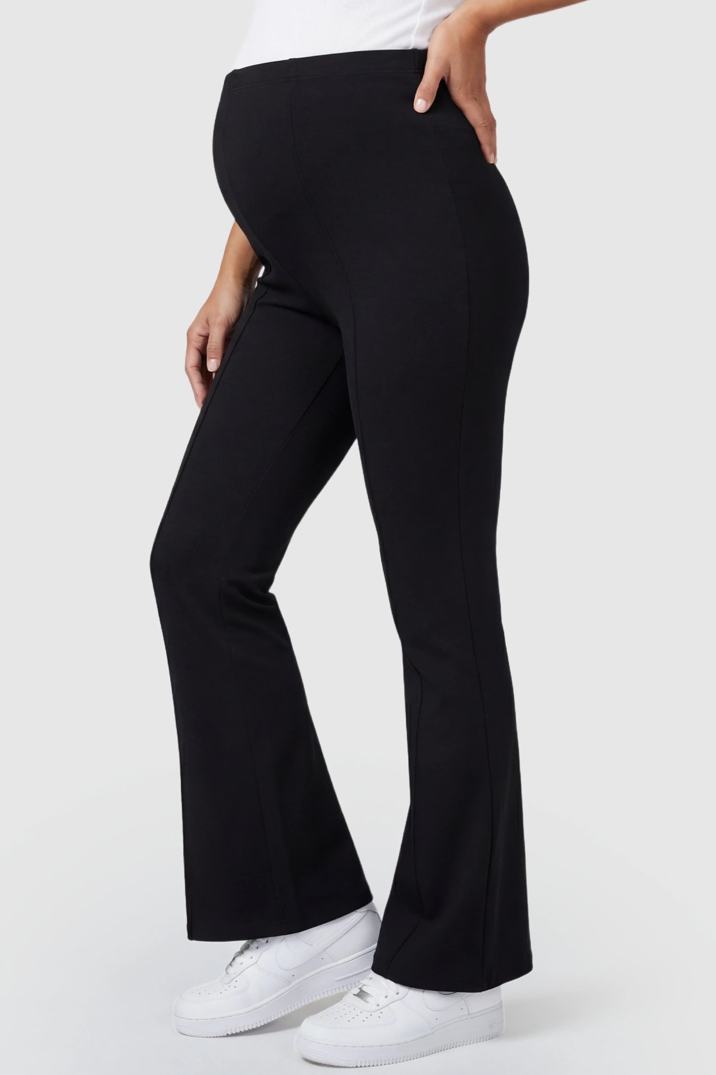 Buttery Soft High Waisted Flare Leg Maternity Pants Buttery Soft High Waisted Flare Leg Maternity Pants in black featuring a visually lengthening flare leg on a pregnant model, side view.