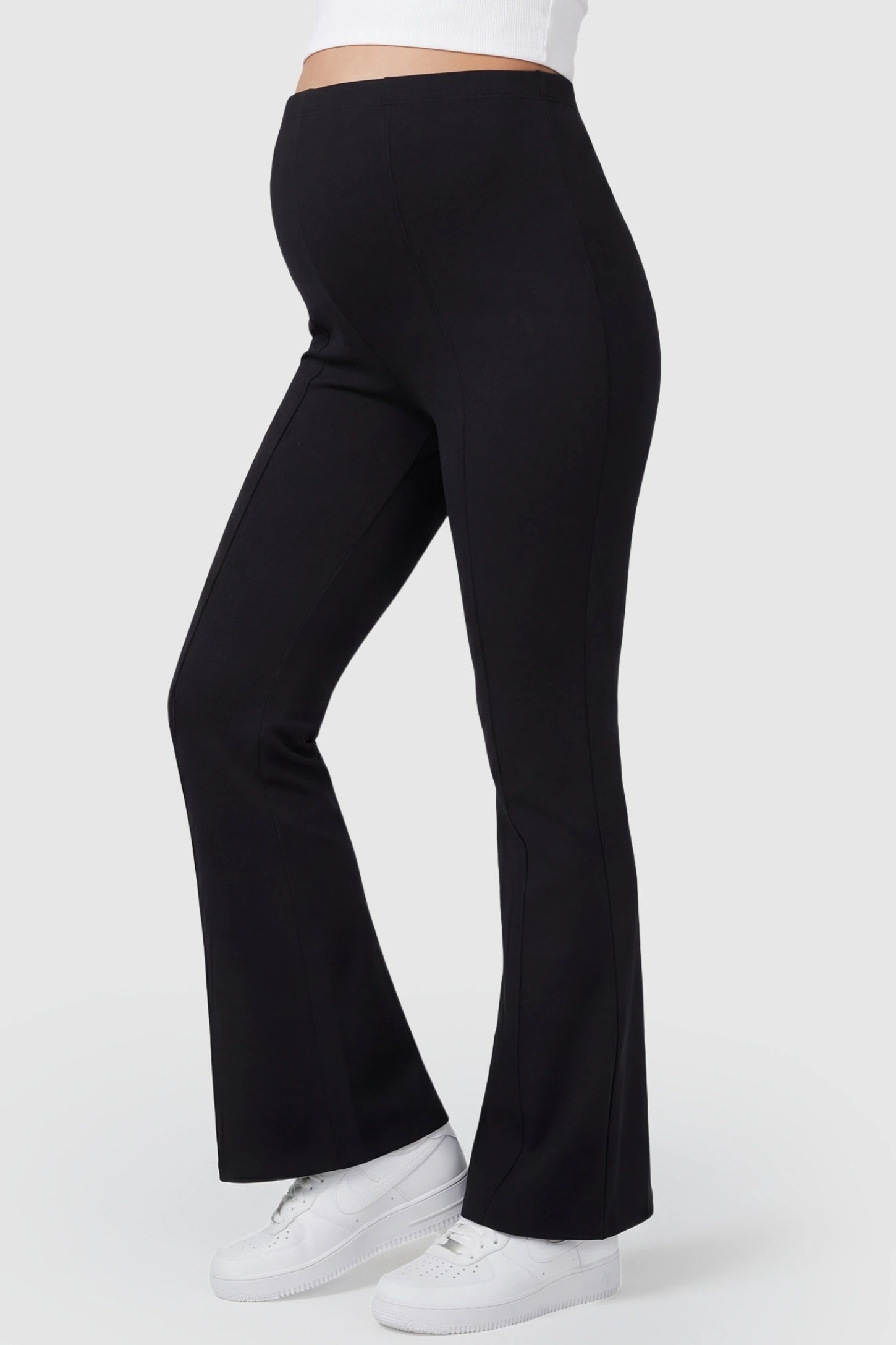 Buttery Soft High Waisted Flare Leg Maternity Pants Buttery Soft High Waisted Flare Leg Maternity Pants in black featuring a visually lengthening flare leg on a pregnant model, side view.