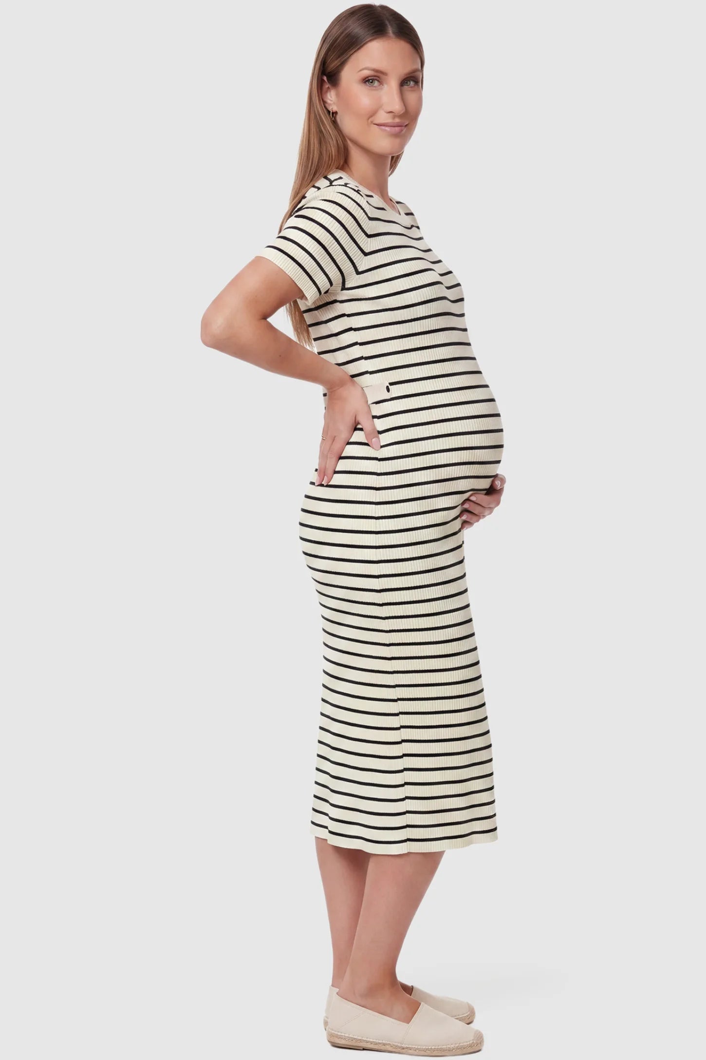 Soft Knit Short Sleeve Bodycon Maternity Midi Dress Soft Knit Short Sleeve Bodycon Maternity Midi Dress in beige stripes with classic stripes, side view on pregnant model