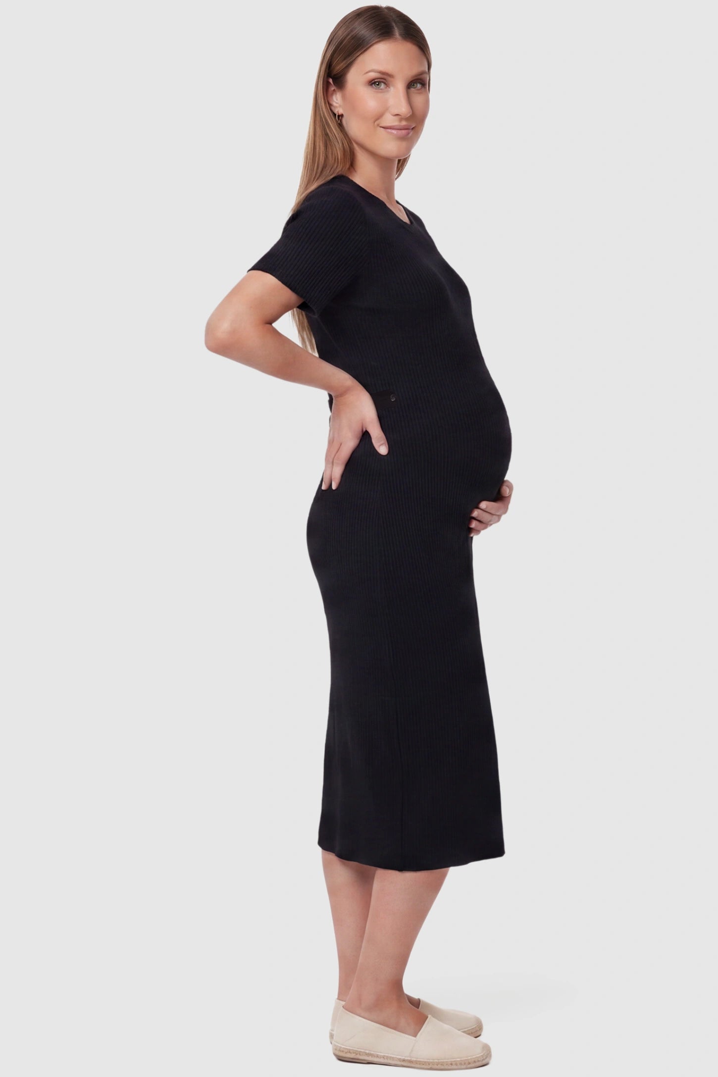 Soft Knit Short Sleeve Bodycon Maternity Midi Dress Soft Knit Short Sleeve Bodycon Maternity Midi Dress in black with short sleeves, side view on pregnant model