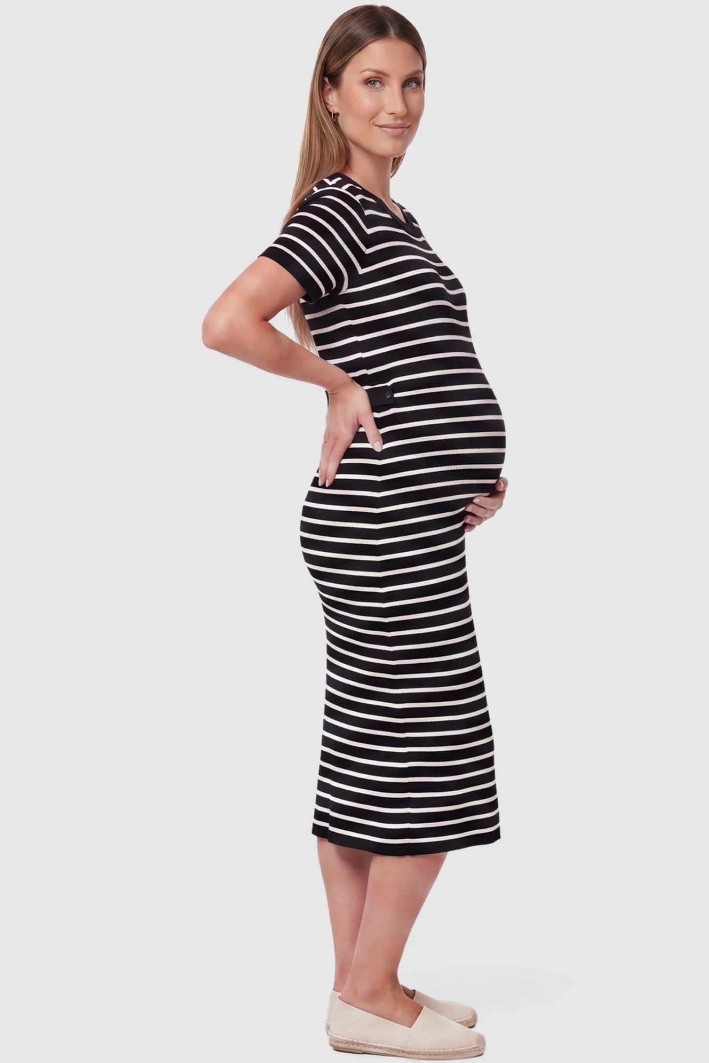 Soft Knit Short Sleeve Bodycon Maternity Midi Dress Soft Knit Short Sleeve Bodycon Maternity Midi Dress in black stripes with classic stripes, side view on pregnant model