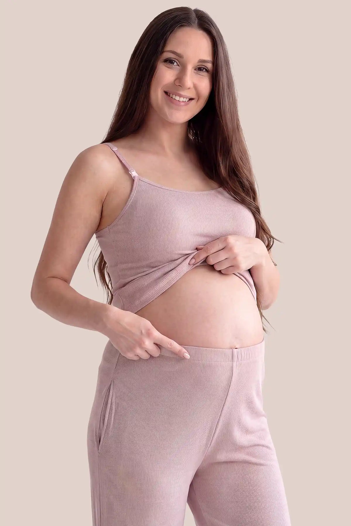 Soft Rib Knit Maternity & Nursing PJ Set with Cami, Cardigan & Pants Soft Rib Knit Maternity & Nursing Pajama Set with Cami, Cardigan & Pants in Soft Pink featuring fine rib knit cami, side-contoured fit, and full over-belly stretch pants on a pregnant model, side view.