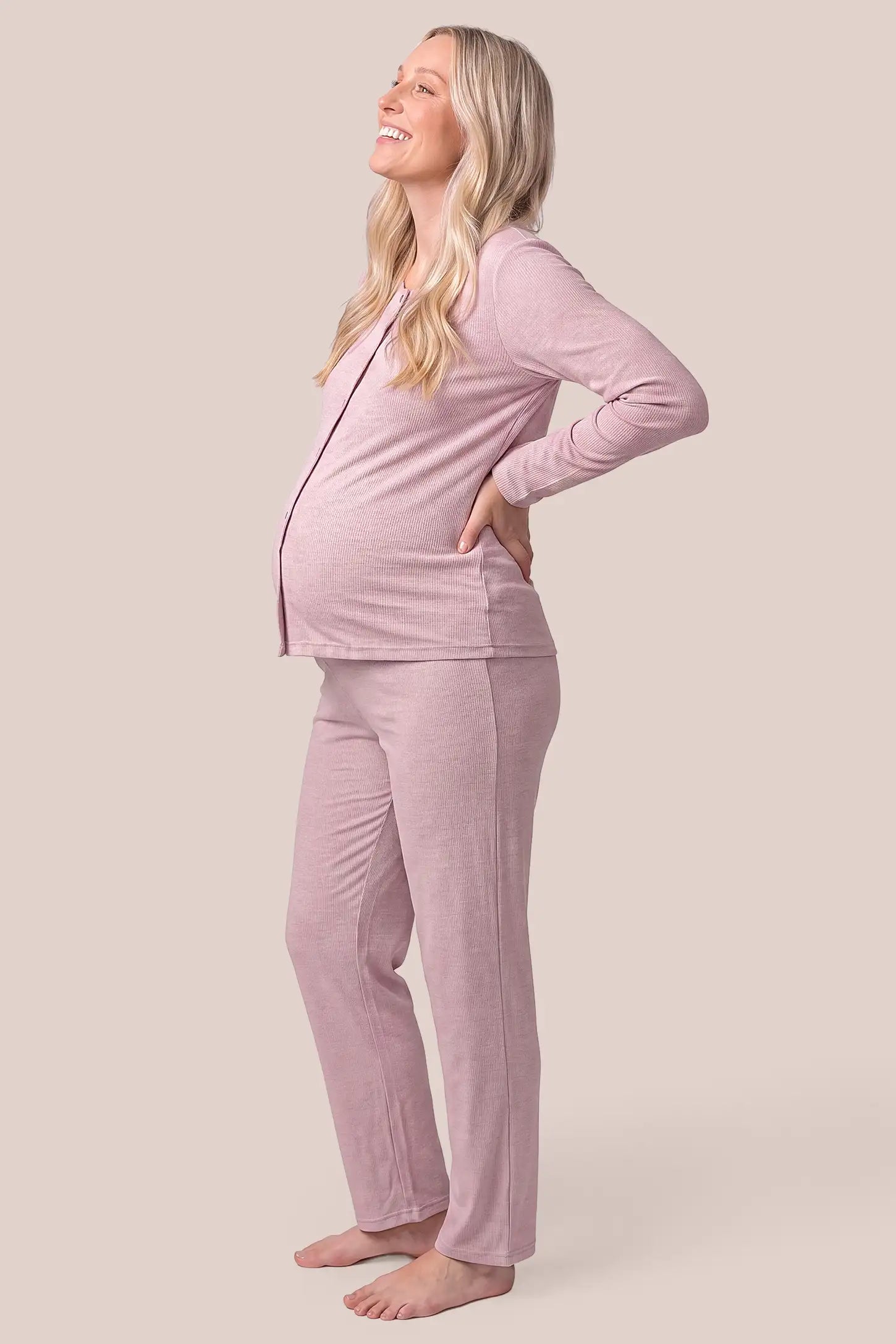 Soft Rib Knit Maternity & Nursing Pajama Set with Cami, Cardigan & Pants in Soft Pink featuring fine rib knit cami, side-contoured fit, and full over-belly stretch pants on a pregnant model, side view.