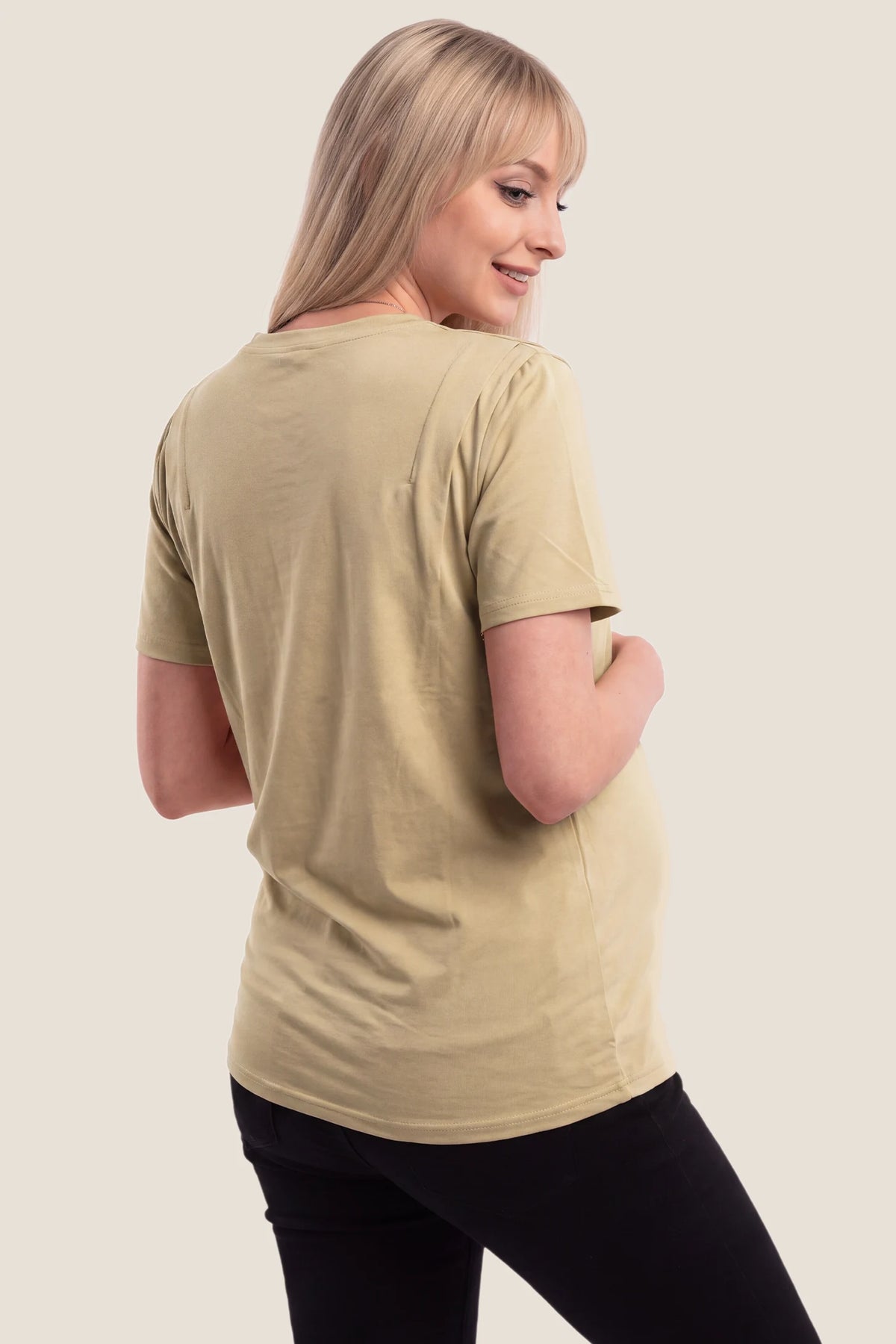 Solid Round Neck Short Sleeve Maternity Top Solid Round Neck Short Sleeve Maternity Top in Brown featuring a simple back design, soft-touch fabric, short sleeves, and a comfortable maternity silhouette on a pregnant model, back view.