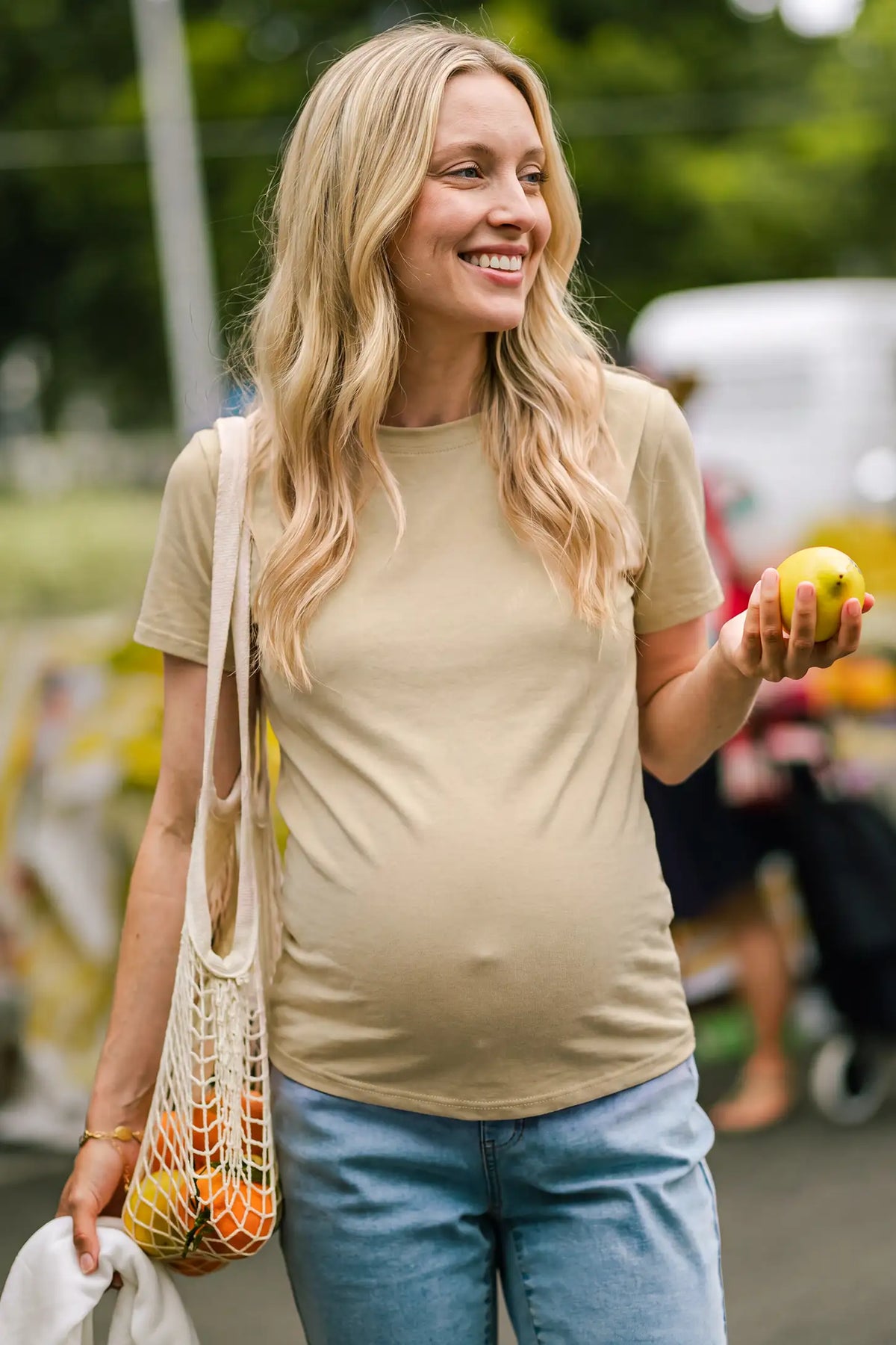 Solid Round Neck Short Sleeve Maternity Top Solid Round Neck Short Sleeve Maternity Top in Brown featuring a classic round neckline, soft-touch fabric, and comfortable short sleeves on a pregnant model in an editorial lifestyle setting.