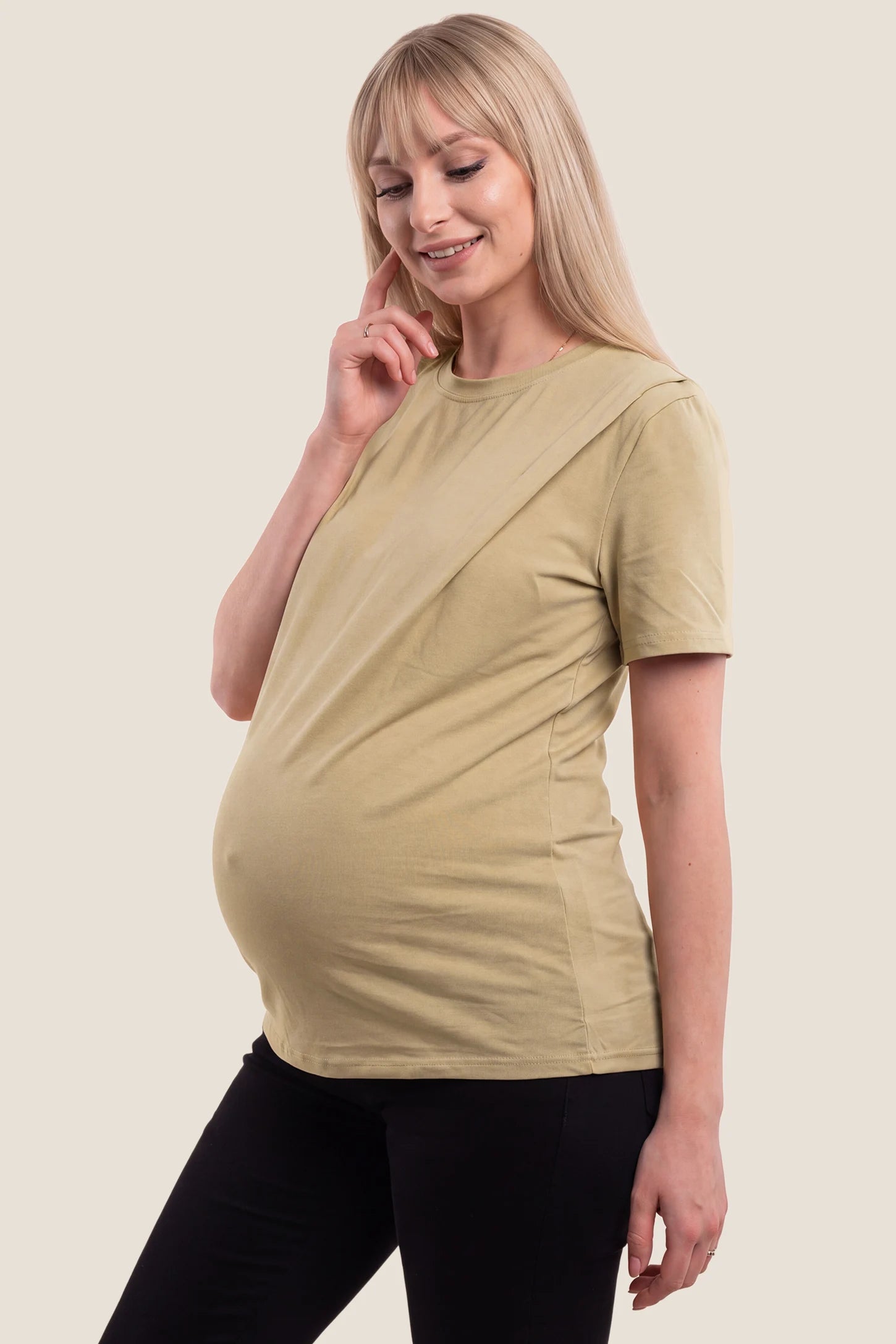 Solid Round Neck Short Sleeve Maternity Top Solid Round Neck Short Sleeve Maternity Top in Brown featuring a round neckline, soft-touch fabric, short sleeves, and a relaxed maternity-friendly silhouette on a pregnant model, side view.