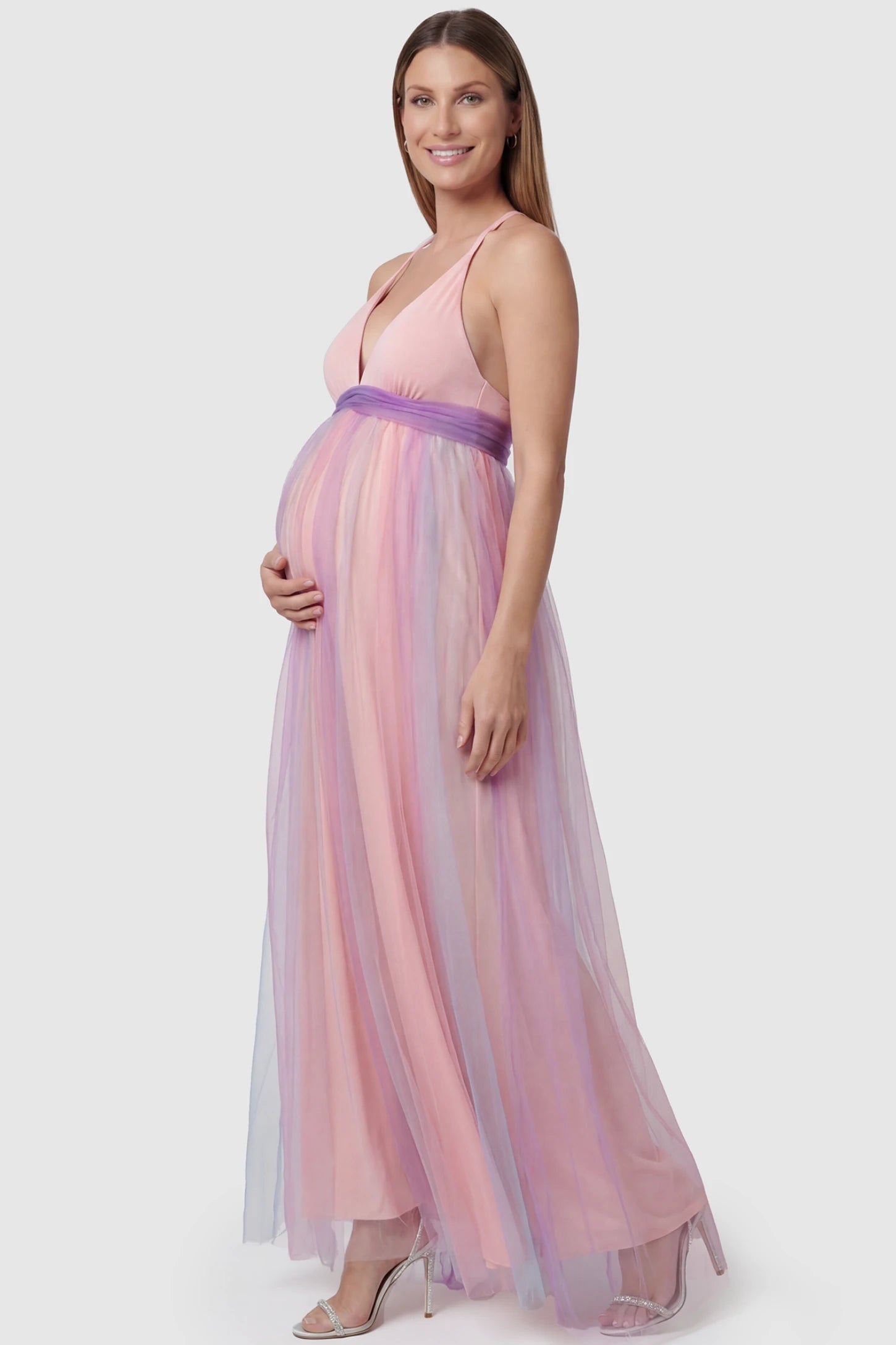 Rainbow Gradient Deep V-Neck Maternity Dress Rainbow Gradient Deep V-Neck Maternity Dress in gradient tulle featuring crossover bodice and empire waist on a pregnant model. side view