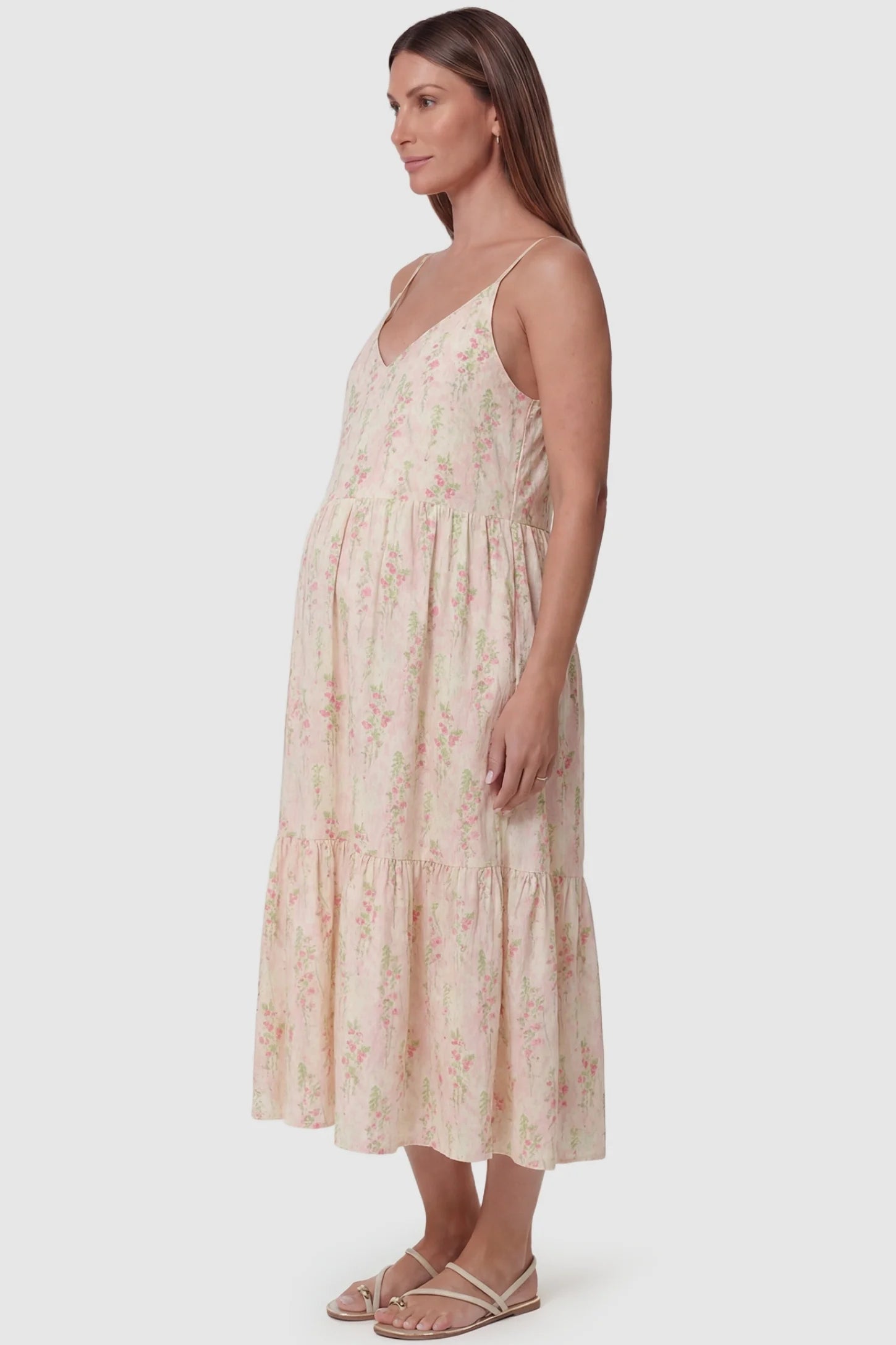 Pink White Ditsy Floral V-Neck Tiered Maxi Maternity Dress featuring a tiered skirt on the side of a pregnant model.