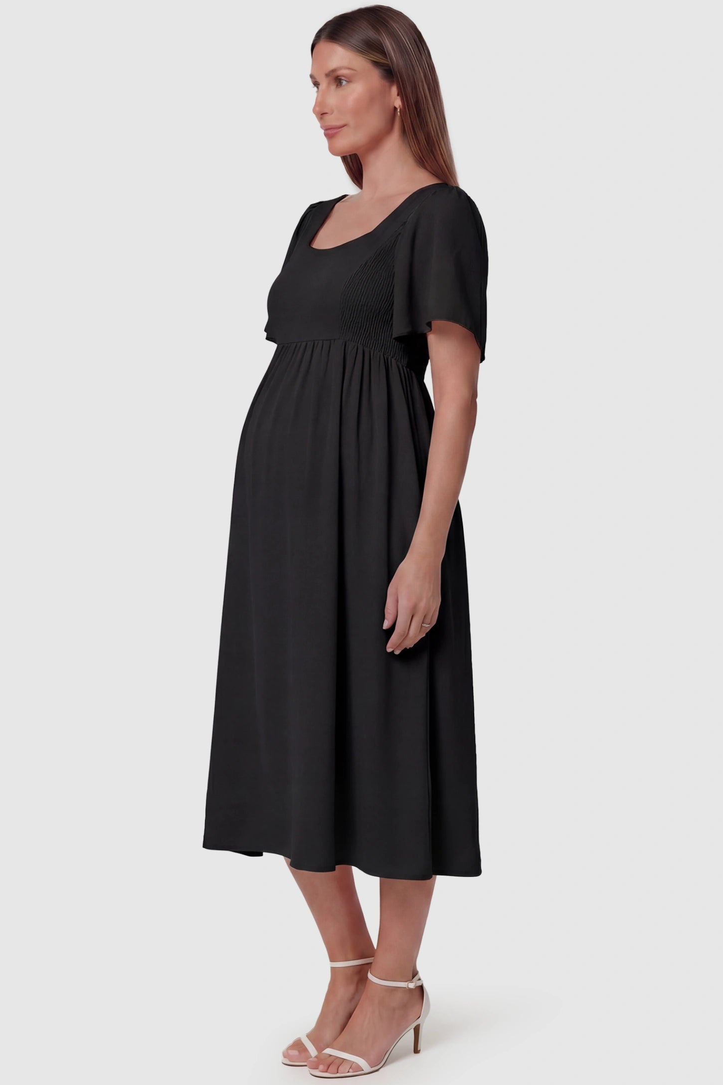 Square Neck Short Sleeve Large Swing Midi Maternity Dress Square neck short sleeve large swing midi maternity dress in black featuring extra-large swing skirt in side view on a pregnant model