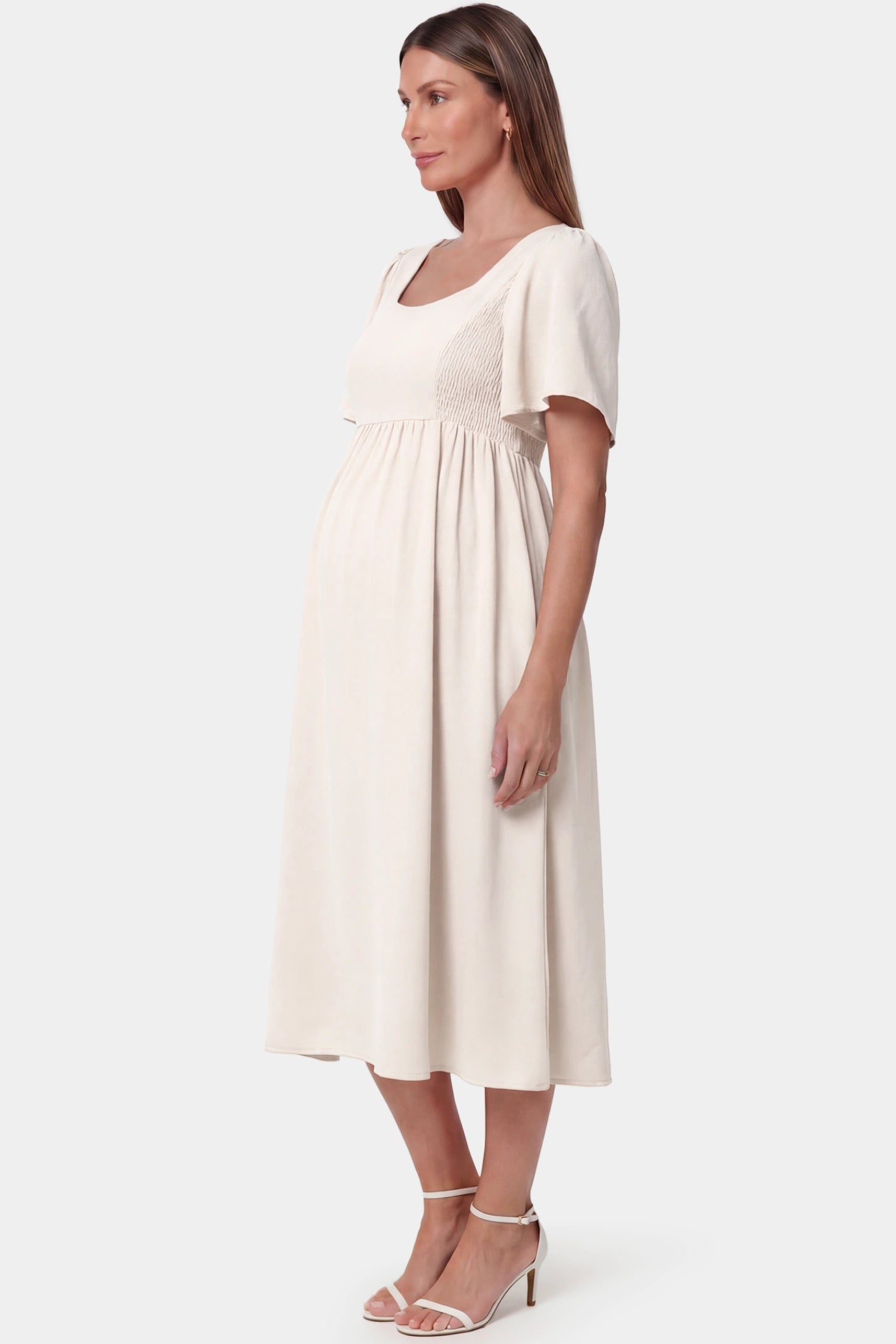 Square Neck Short Sleeve Large Swing Midi Maternity Dress Square neck short sleeve large swing midi maternity dress in ivory white featuring extra-large swing skirt in side view on a pregnant model