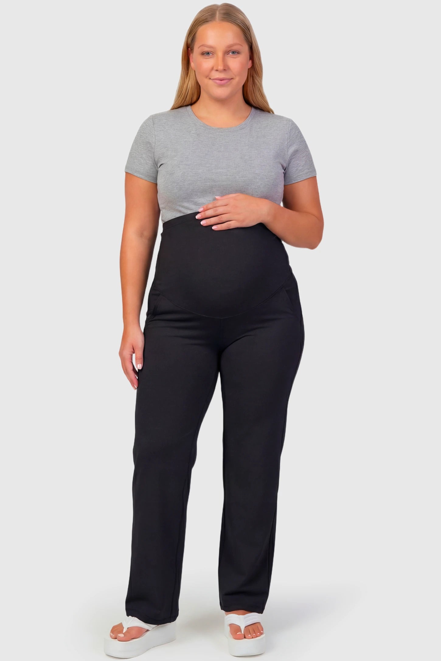 High-Waisted Straight-Leg Maternity Pants High Waisted Straight-Leg Maternity Pants in black featuring over-the-belly support and standard length fit on plus size pregnant model.