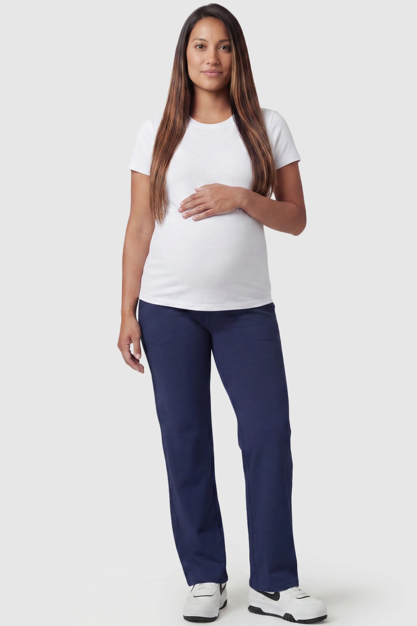 High-Waisted Straight-Leg Maternity Pants High Waisted Straight-Leg Maternity Pants in navy blue featuring over-the-belly support and standard length fit on pregnant model, full body view.