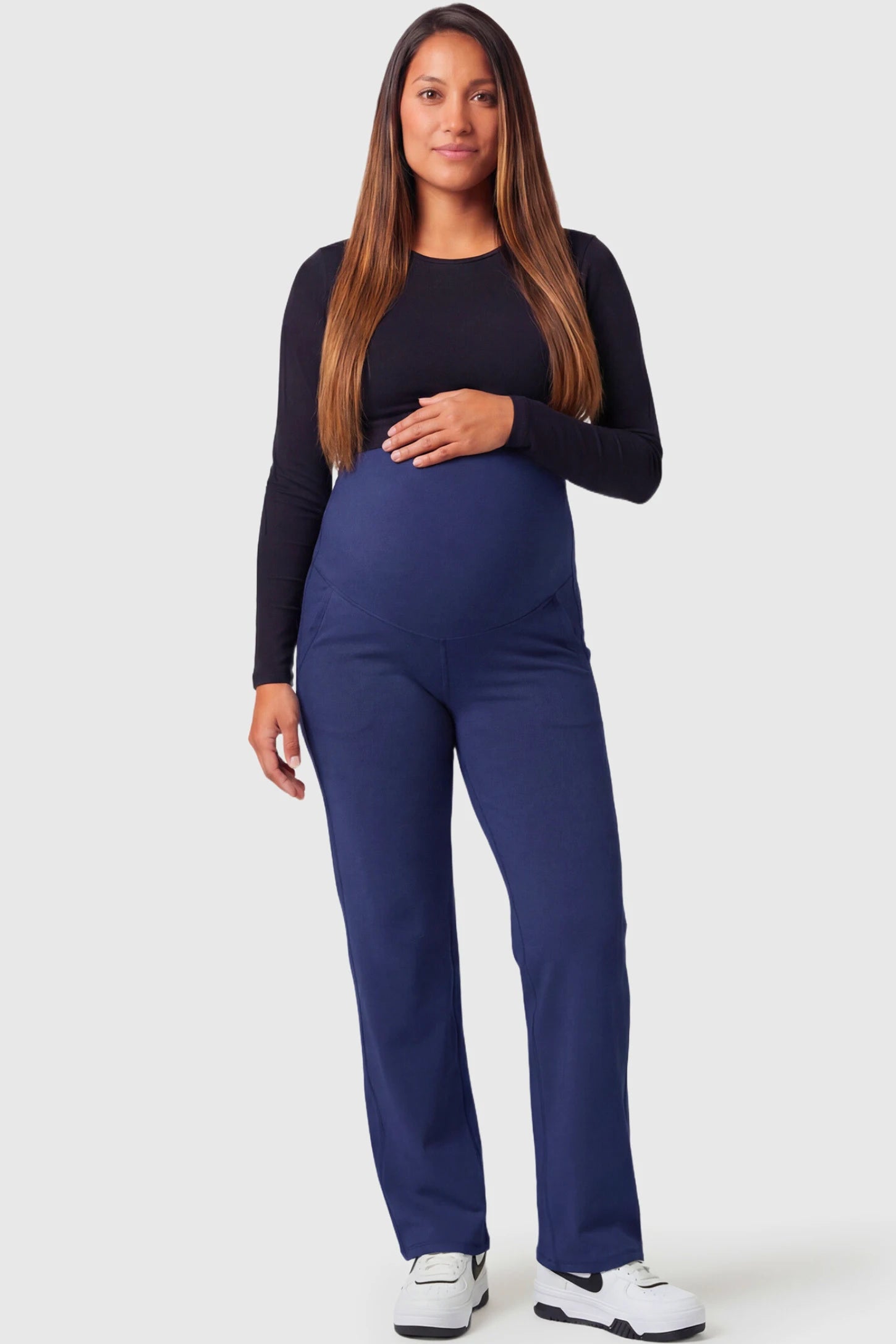 High-Waisted Straight-Leg Maternity Pants High Waisted Straight-Leg Maternity Pants in navy blue featuring over-the-belly support and standard length fit on pregnant model.