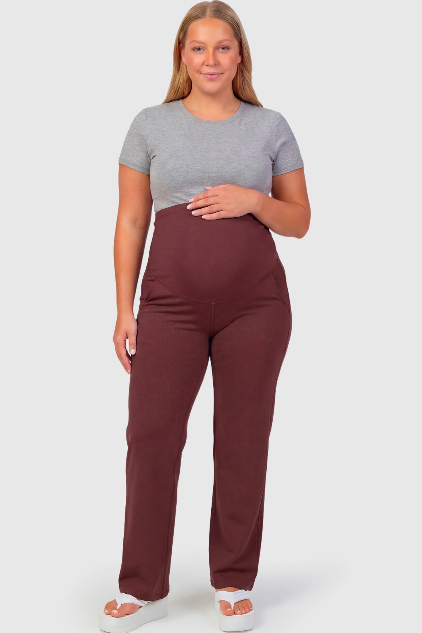 High-Waisted Straight-Leg Maternity Pants High Waisted Straight-Leg Maternity Pants in wine red featuring over-the-belly support and standard length fit on plus size pregnant model.