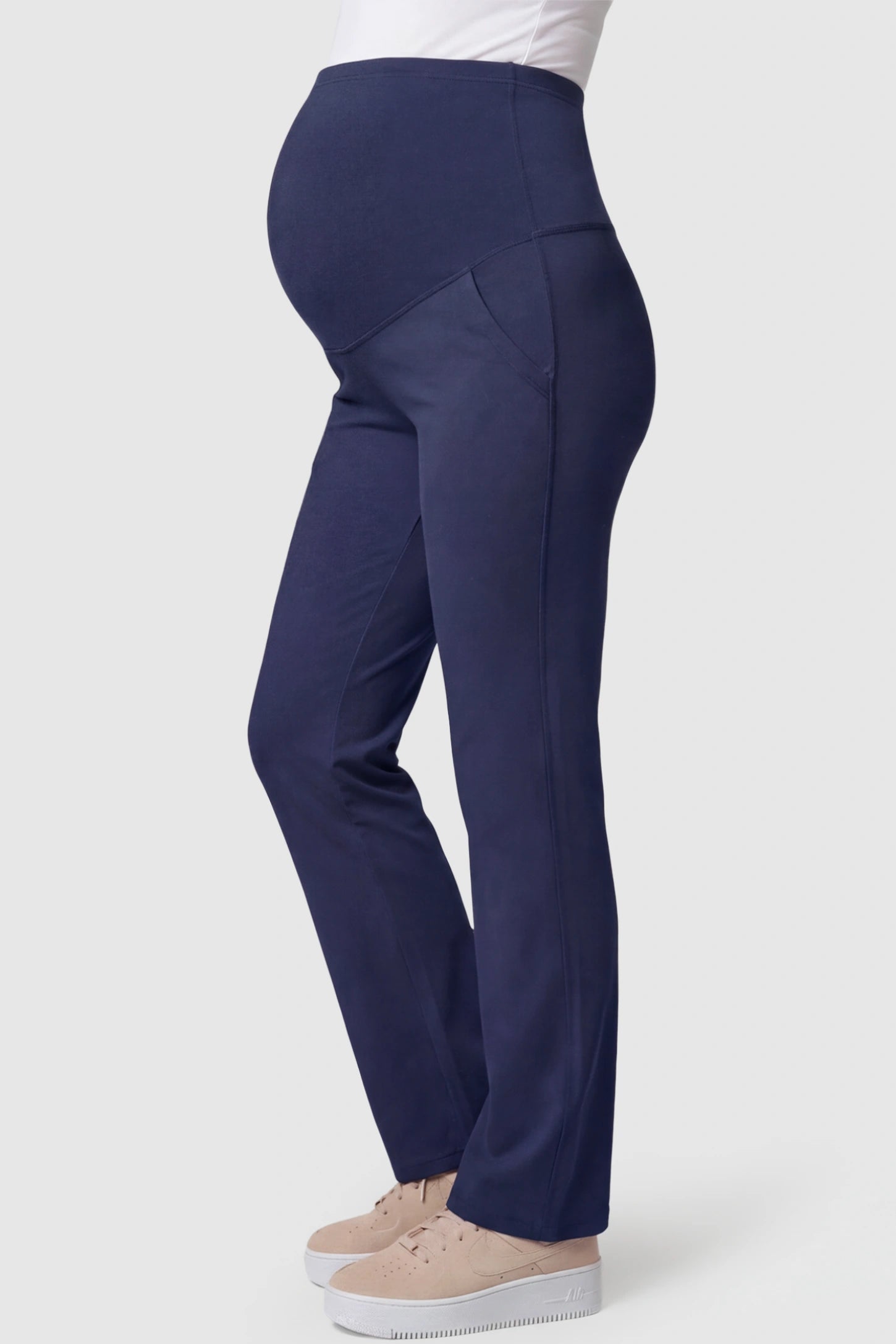 High-Waisted Straight-Leg Maternity Pants High Waisted Straight-Leg Maternity Pants in navy blue featuring over-the-belly support and standard length fit on pregnant model side view.