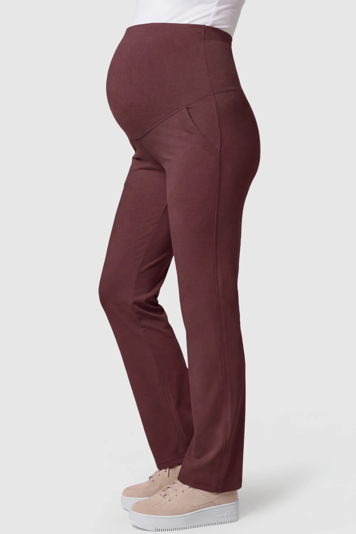 High-Waisted Straight-Leg Maternity Pants High Waisted Straight-Leg Maternity Pants in wine red featuring over-the-belly support and standard length fit on pregnant model side view.