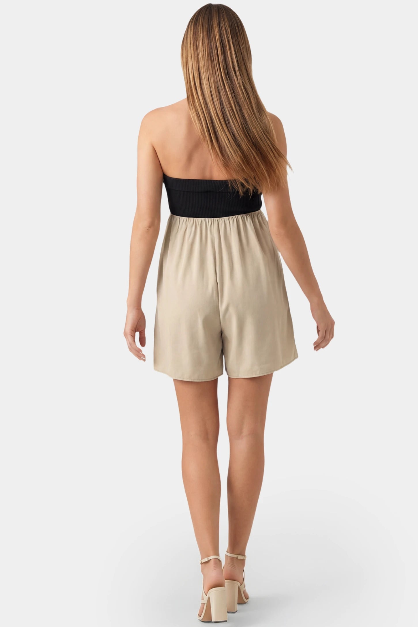 Color-Block Strapless High-Waist Flared Mini Maternity Dress Color-block strapless high-waist flared mini maternity dress in black and apricot featuring chic color-block detail in back view on a pregnant model