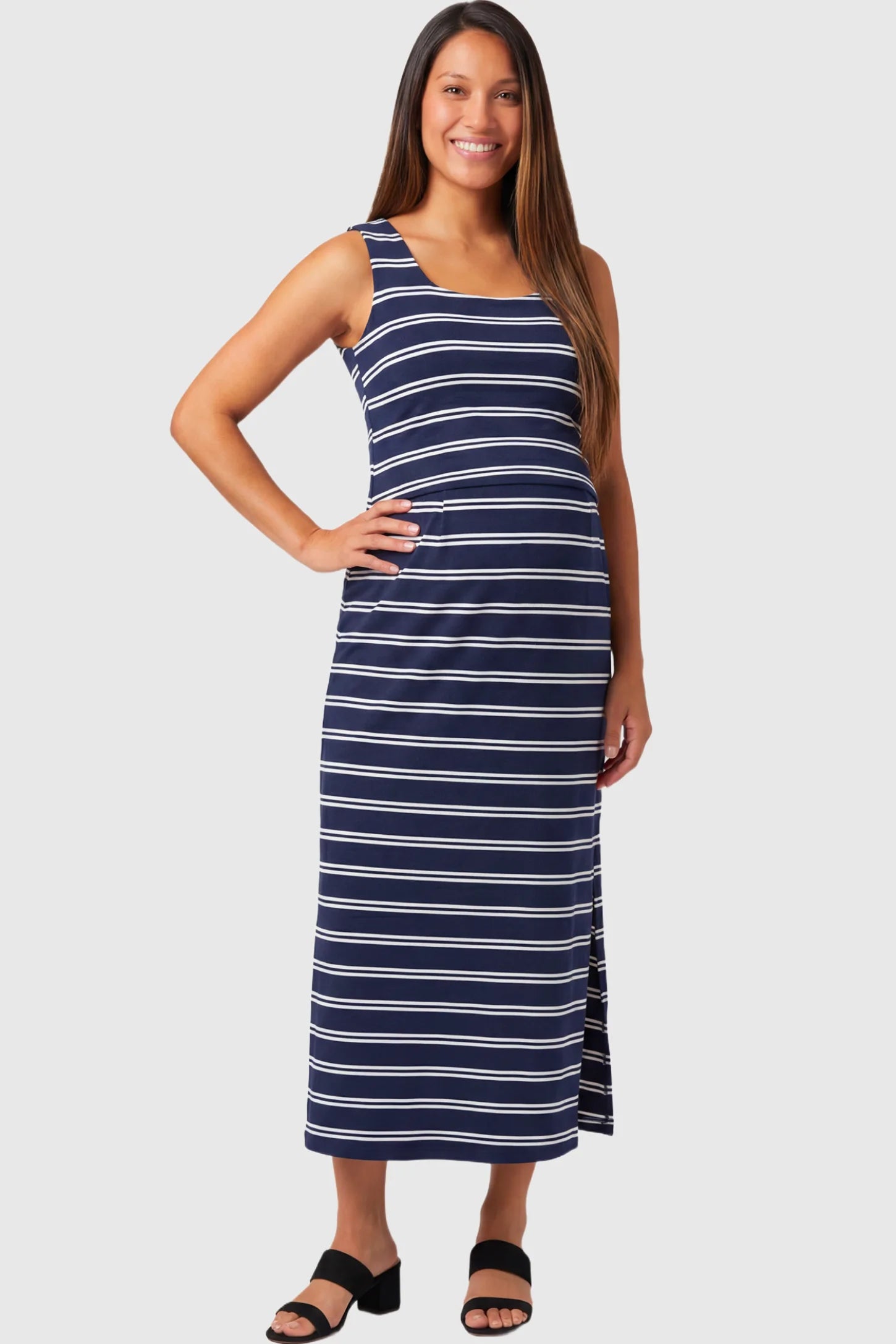 Sleeveless Scoop Neck Maternity & Nursing Midi Dress in navy stripe pattern featuring scoop neckline and side slit on a pregnant model.