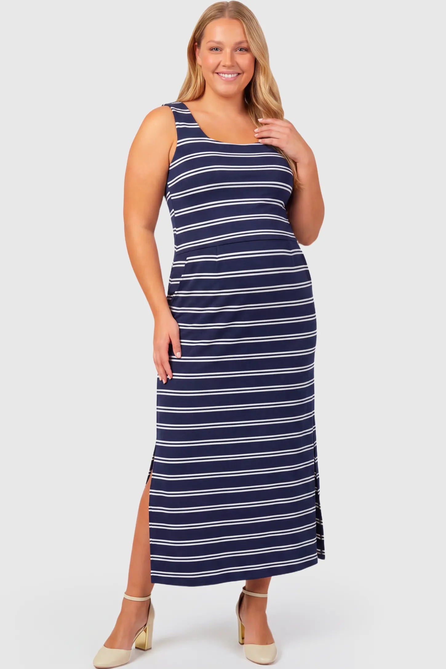 Sleeveless Scoop Neck Maternity & Nursing Midi Dress Sleeveless Scoop Neck Maternity & Nursing Midi Dress in navy stripe pattern featuring scoop neckline and side slit on a plus size pregnant model.