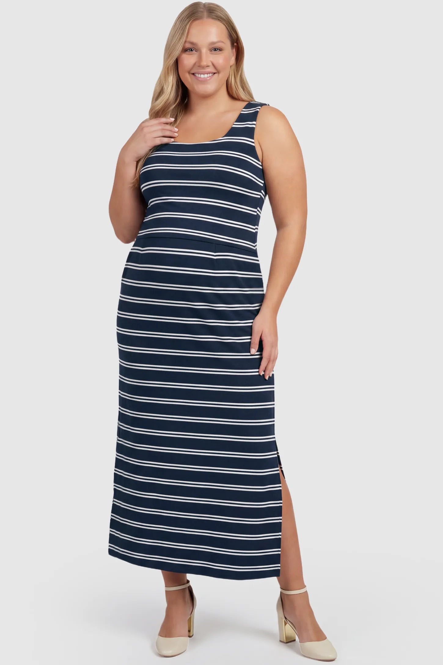 Sleeveless Scoop Neck Maternity & Nursing Midi Dress Sleeveless Scoop Neck Maternity & Nursing Midi Dress in dark blue stripes with classic stripes and side slit, front view on plus-size model