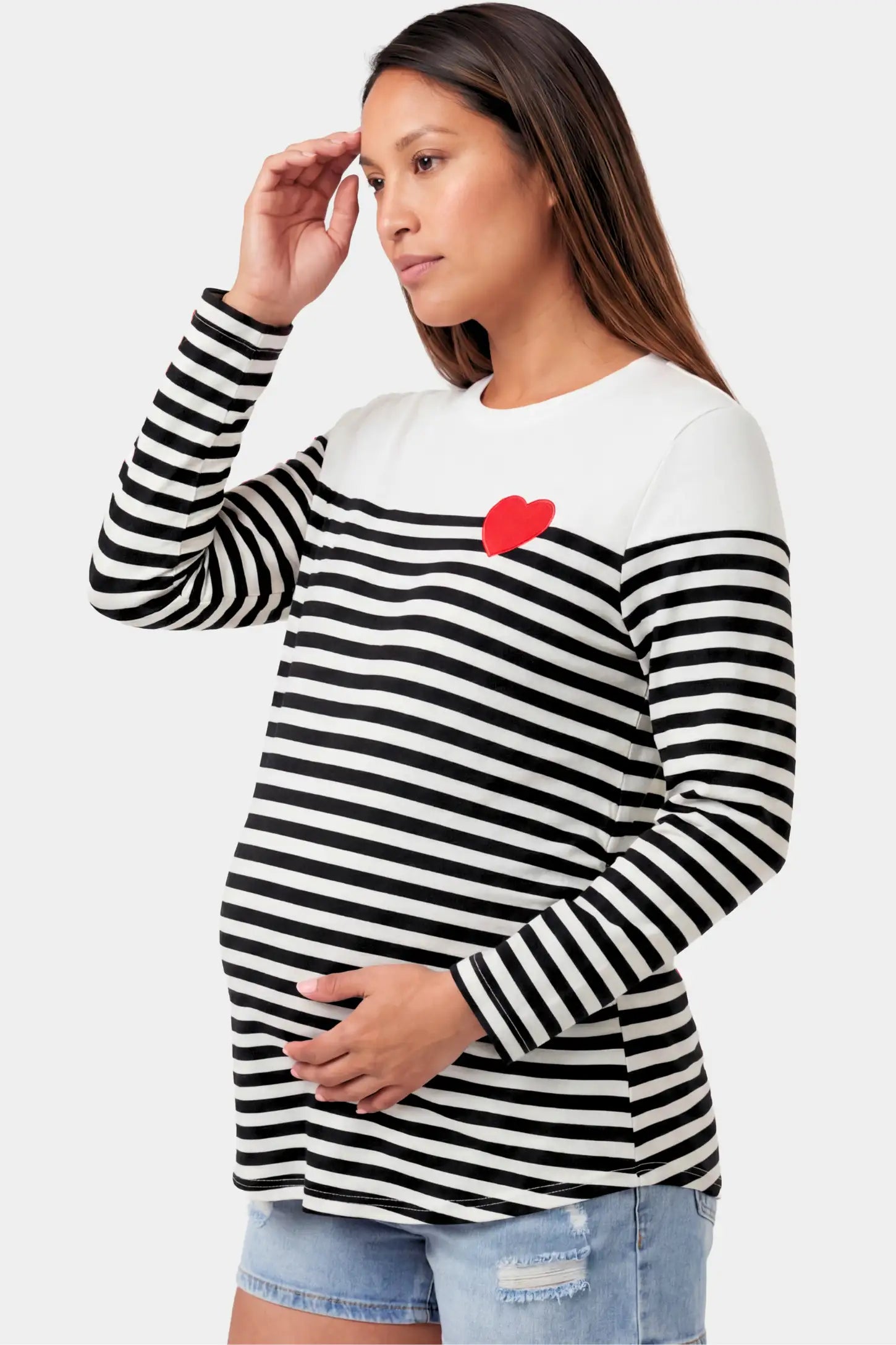 Striped Crew Neck Long Sleeve Maternity Top Striped Crew Neck Long Sleeve Maternity Top in black featuring a crew neck and heart detail on a pregnant model.