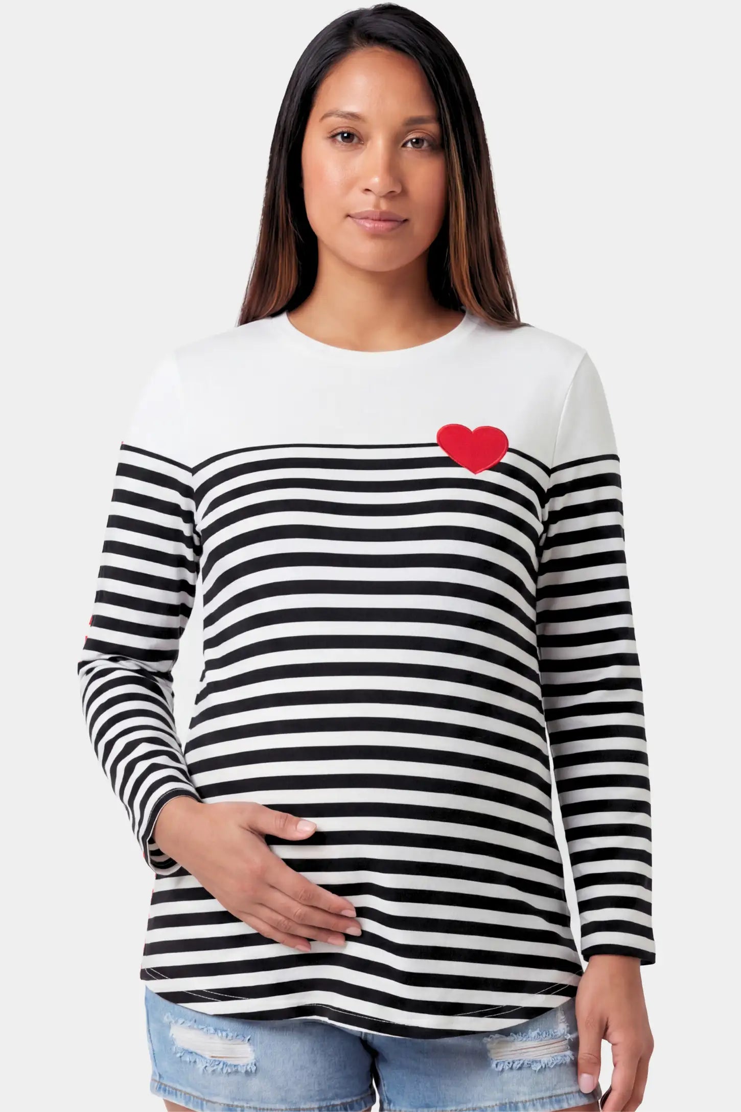 Striped Crew Neck Long Sleeve Maternity Top Striped Crew Neck Long Sleeve Maternity Top in black featuring a crew neck and heart detail on a pregnant model.