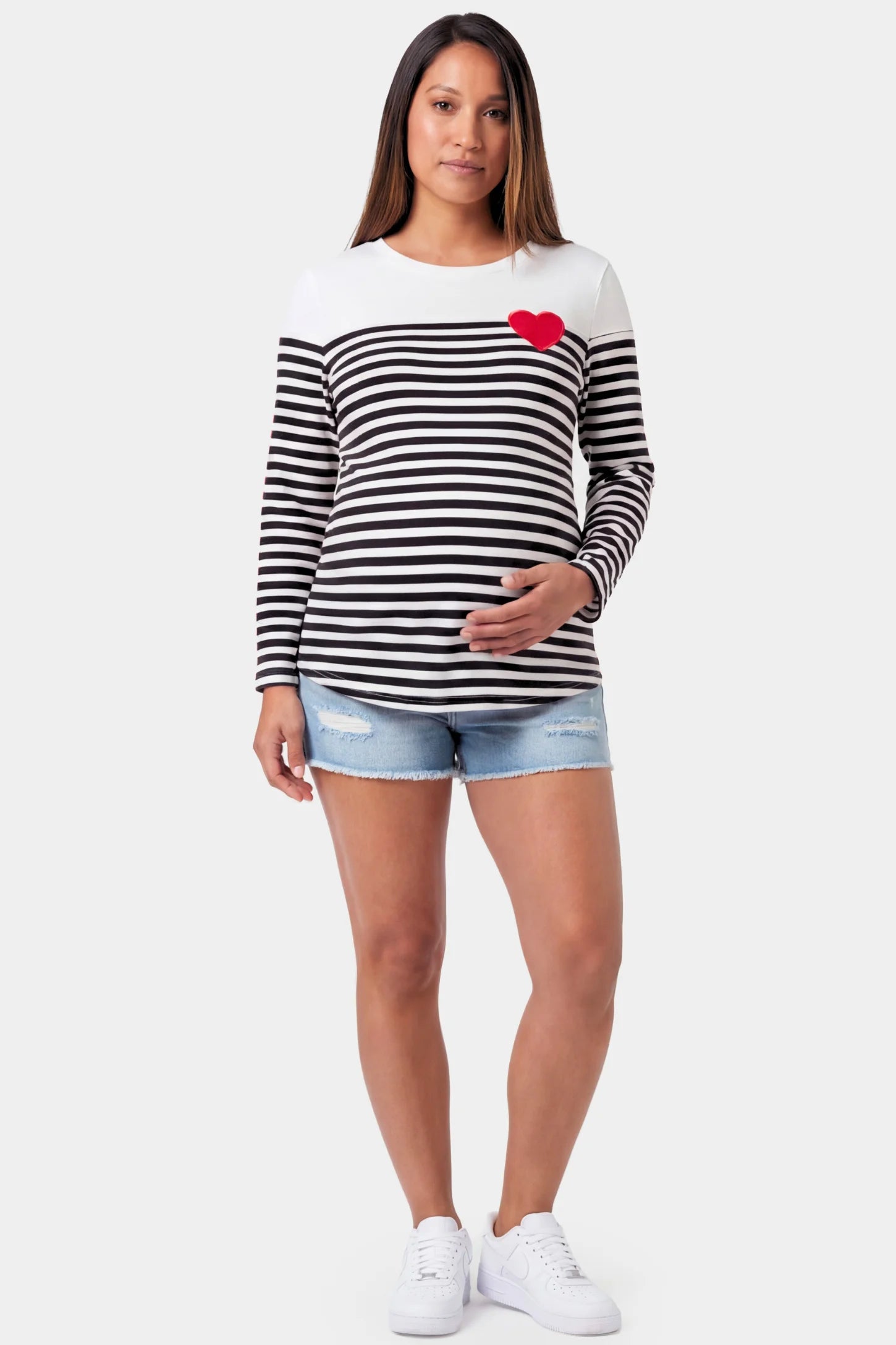 Striped Crew Neck Long Sleeve Maternity Top Striped Crew Neck Long Sleeve Maternity Top in black featuring a crew neck and heart detail on a pregnant model.