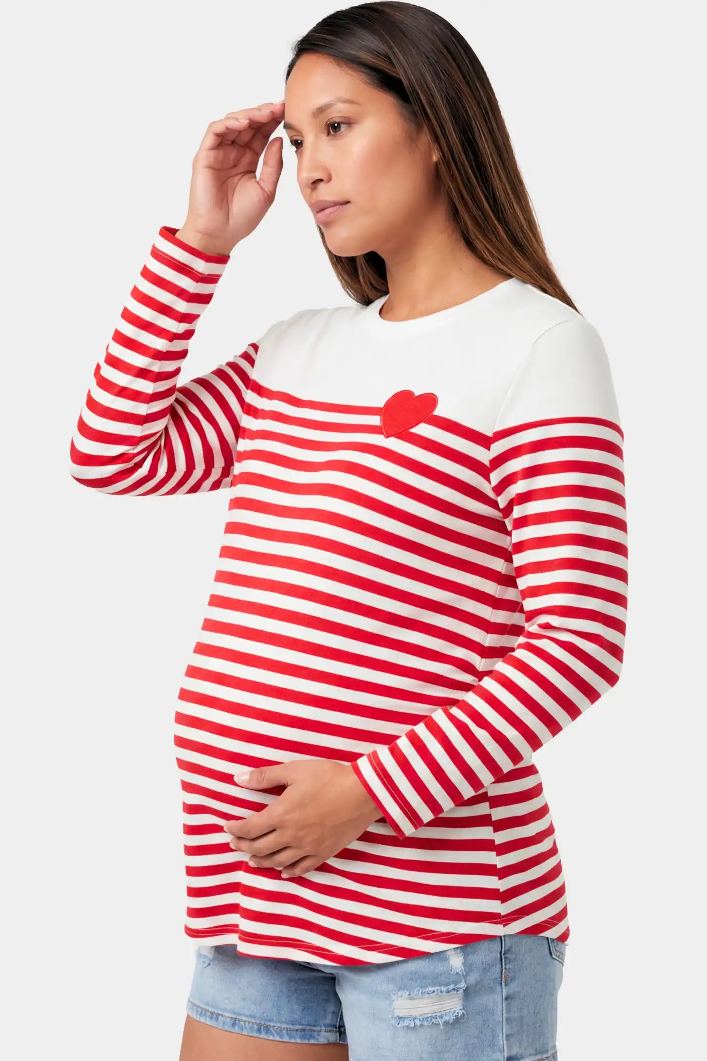 Striped Crew Neck Long Sleeve Maternity Top in red featuring a crew neck and heart detail on a pregnant model.