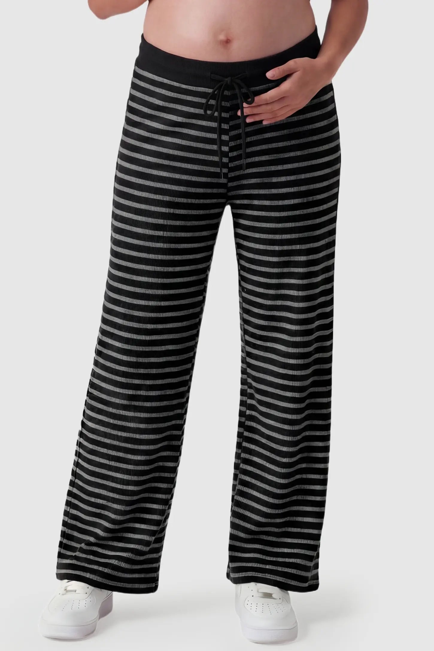 Striped Knit Drawstring Wide-Leg Maternity Pants Striped Knit Drawstring Wide-Leg Maternity Pants in black stripes featuring a high-rise waist on a pregnant model, front view.