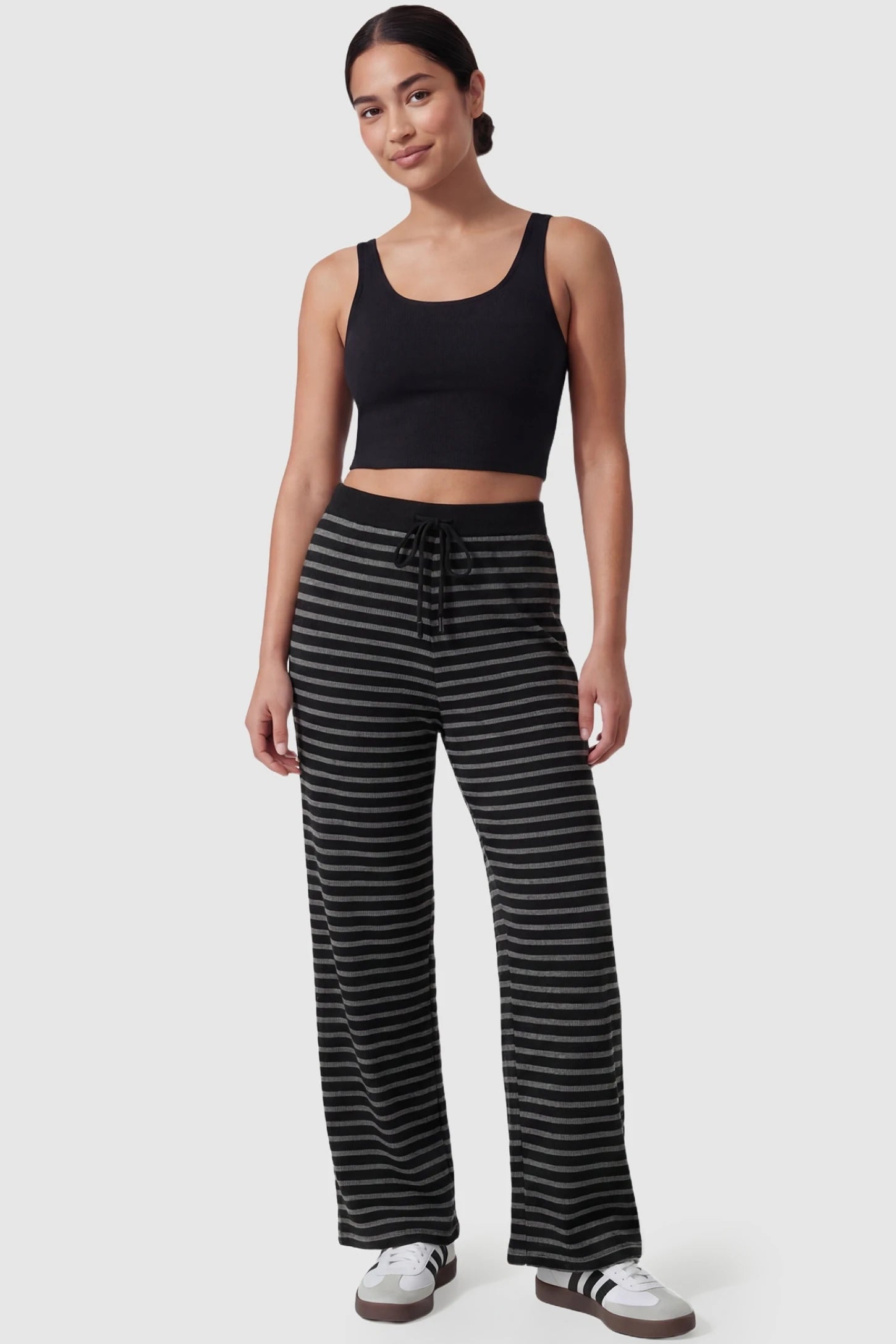 Striped Knit Drawstring Wide-Leg Maternity Pants Striped Knit Drawstring Wide-Leg Maternity Pants in black stripes featuring a high-rise waist on a postpartum model, in full body shot.