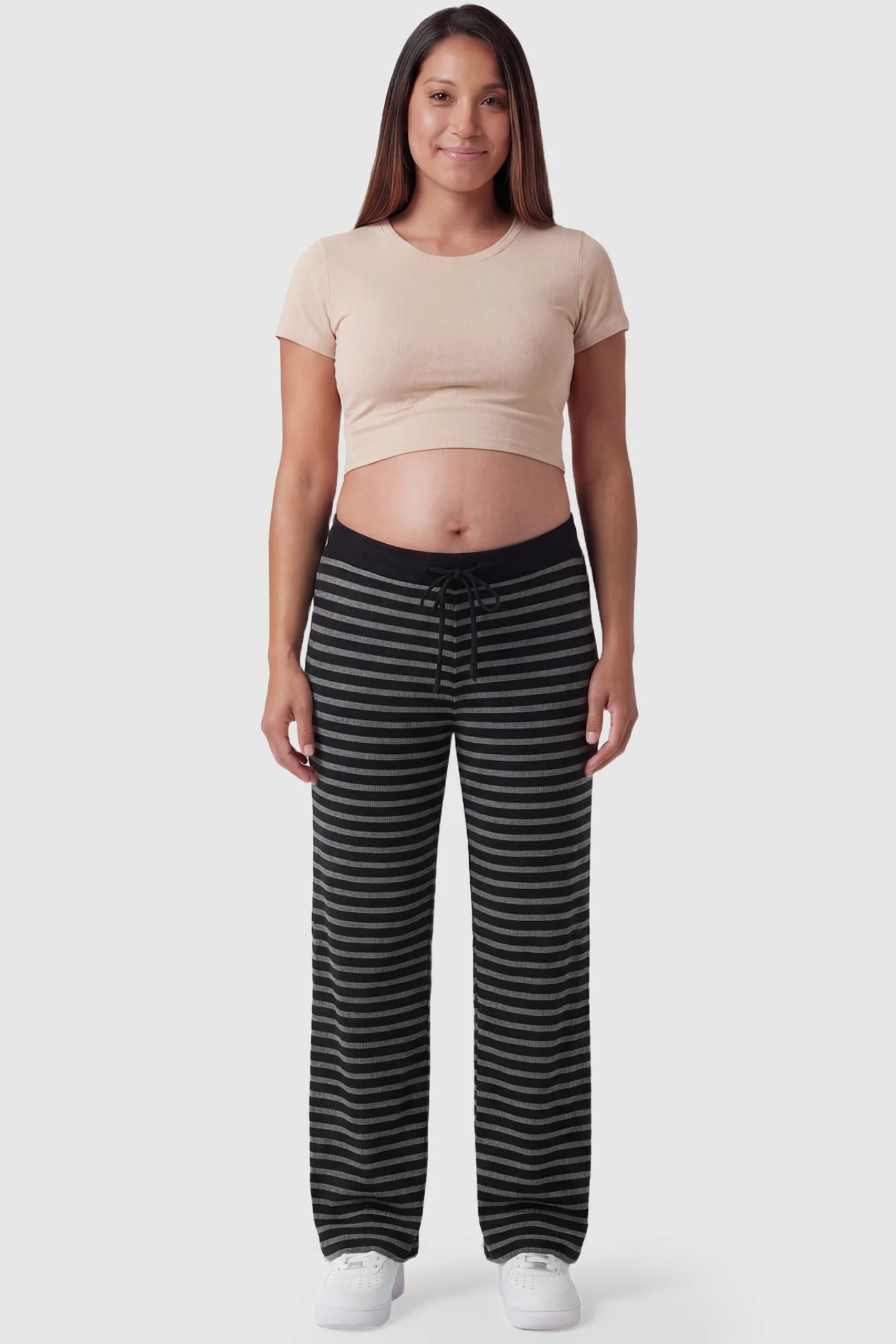 Striped Knit Drawstring Wide-Leg Maternity Pants Striped Knit Drawstring Wide-Leg Maternity Pants in black stripes featuring a high-rise waist on a pregnant model, in full body shot.