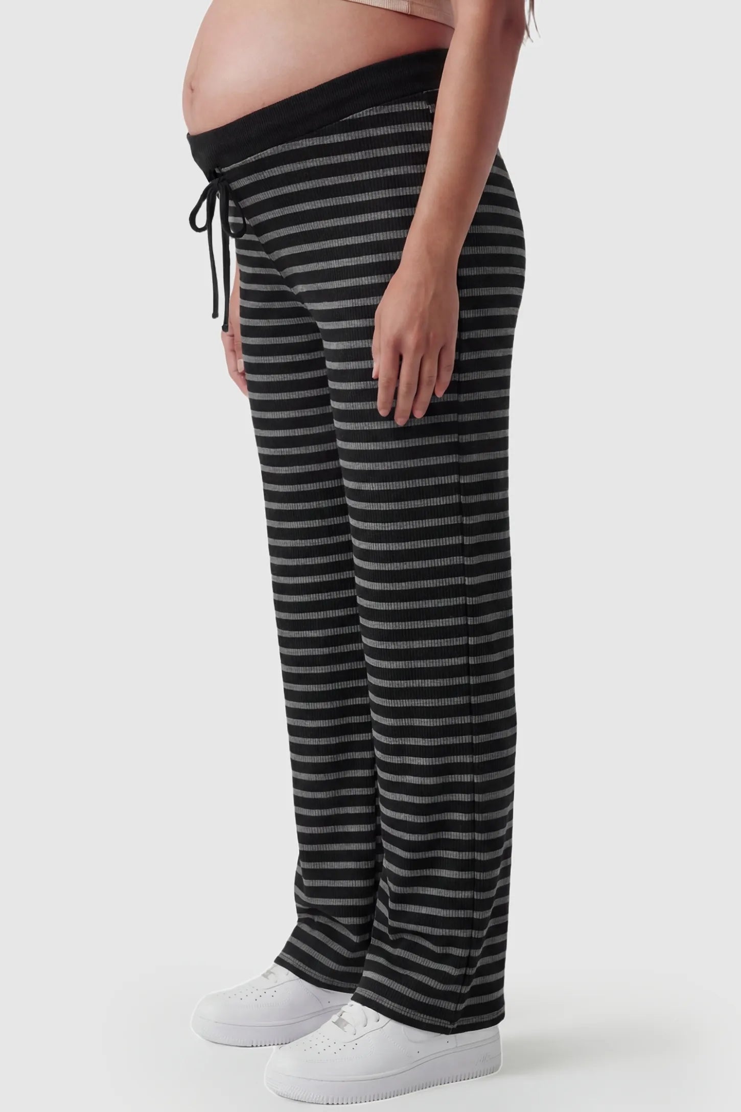Striped Knit Drawstring Wide-Leg Maternity Pants Striped Knit Drawstring Wide-Leg Maternity Pants in black stripes featuring a loose, wide-leg fit on a pregnant model, side view.